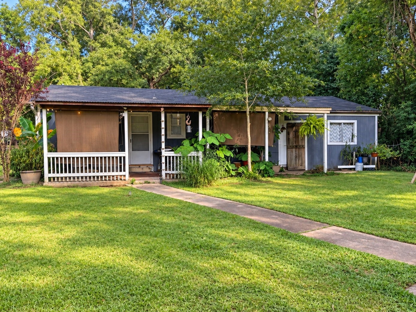 14440 Lakecrest Drive, Splendora, TX 77372 Back House:
Charming rear exterior with covered front porch, mature landscaping, and walkway.