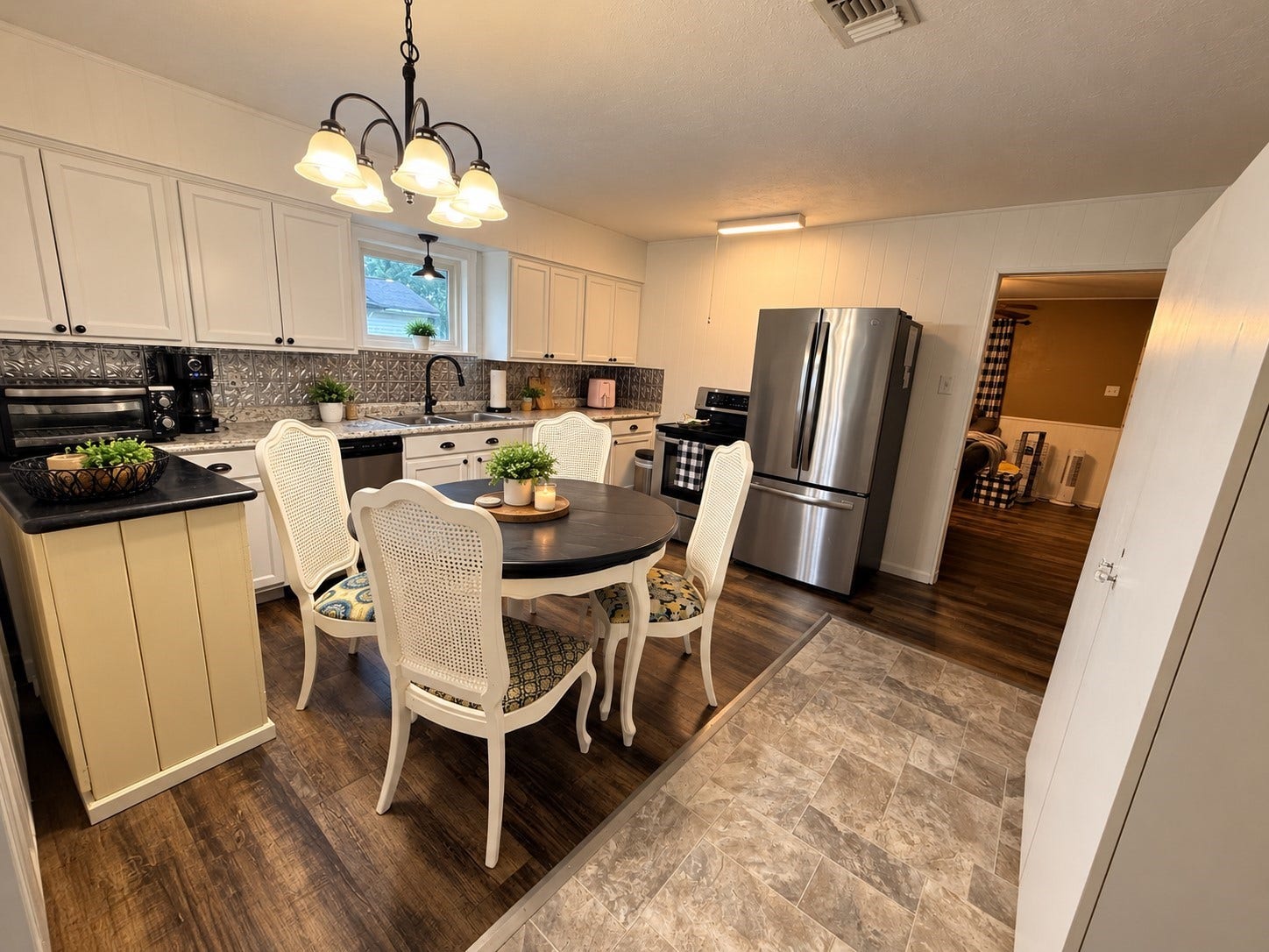 14440 Lakecrest Drive, Splendora, TX 77372 Dining Kitchen: Spacious kitchen and dining area featuring abundant cabinetry, stainless steel appliances, decorative backsplash, and a charming dining nook.