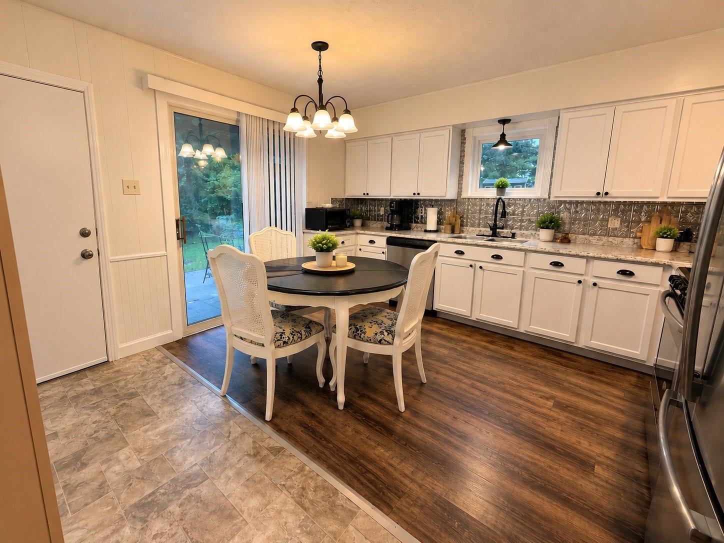 14440 Lakecrest Drive, Splendora, TX 77372 Kitchen & Dining: Open kitchen and dining area with extensive cabinetry, stainless steel appliances, decorative backsplash, and views of the backyard.
