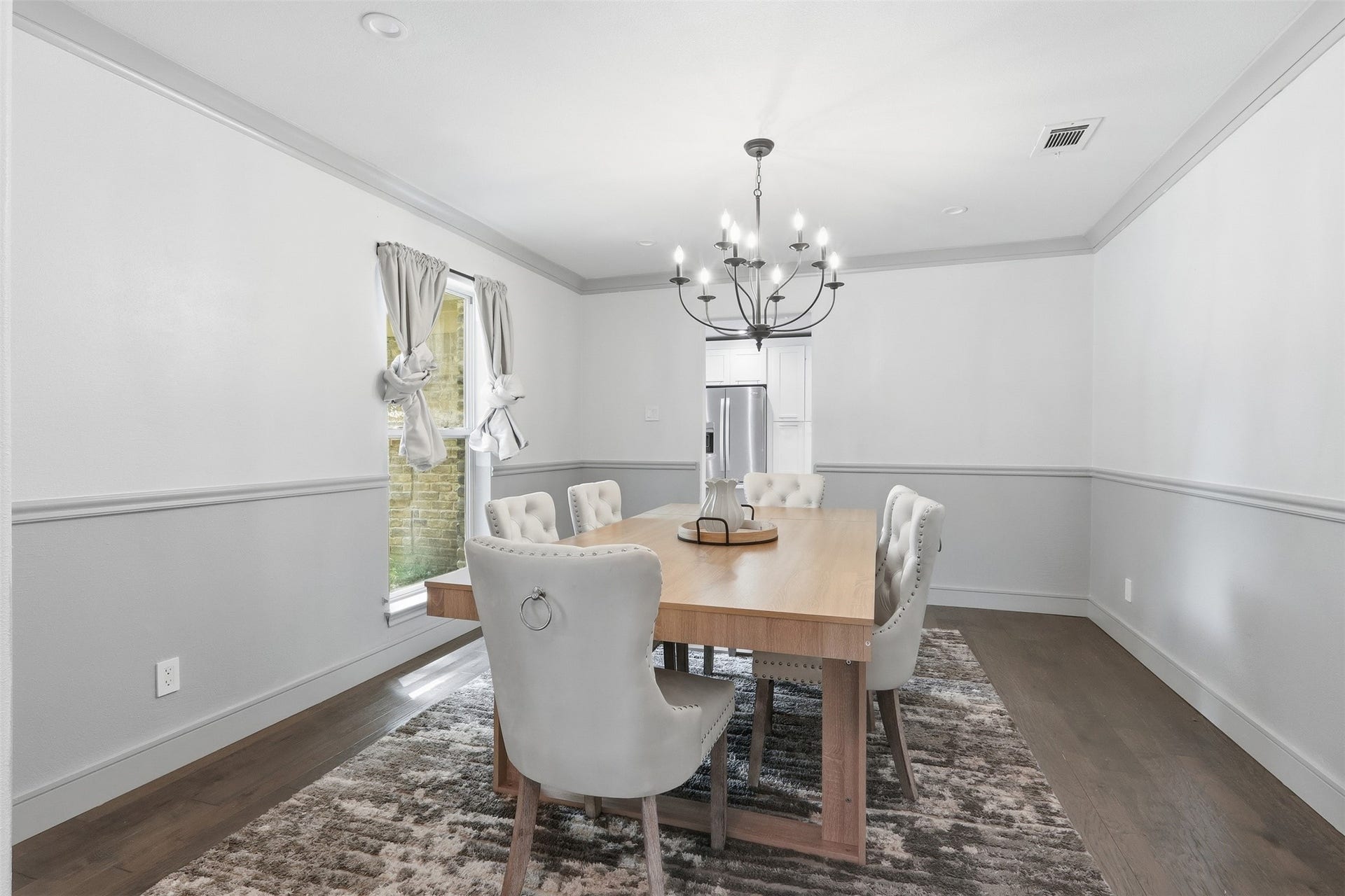 6518 Elmgrove Road, Spring, TX 77389 Elegant formal dining room with beautiful millwork, hardwood floors, and a statement chandelierperfect for hosting and gathering