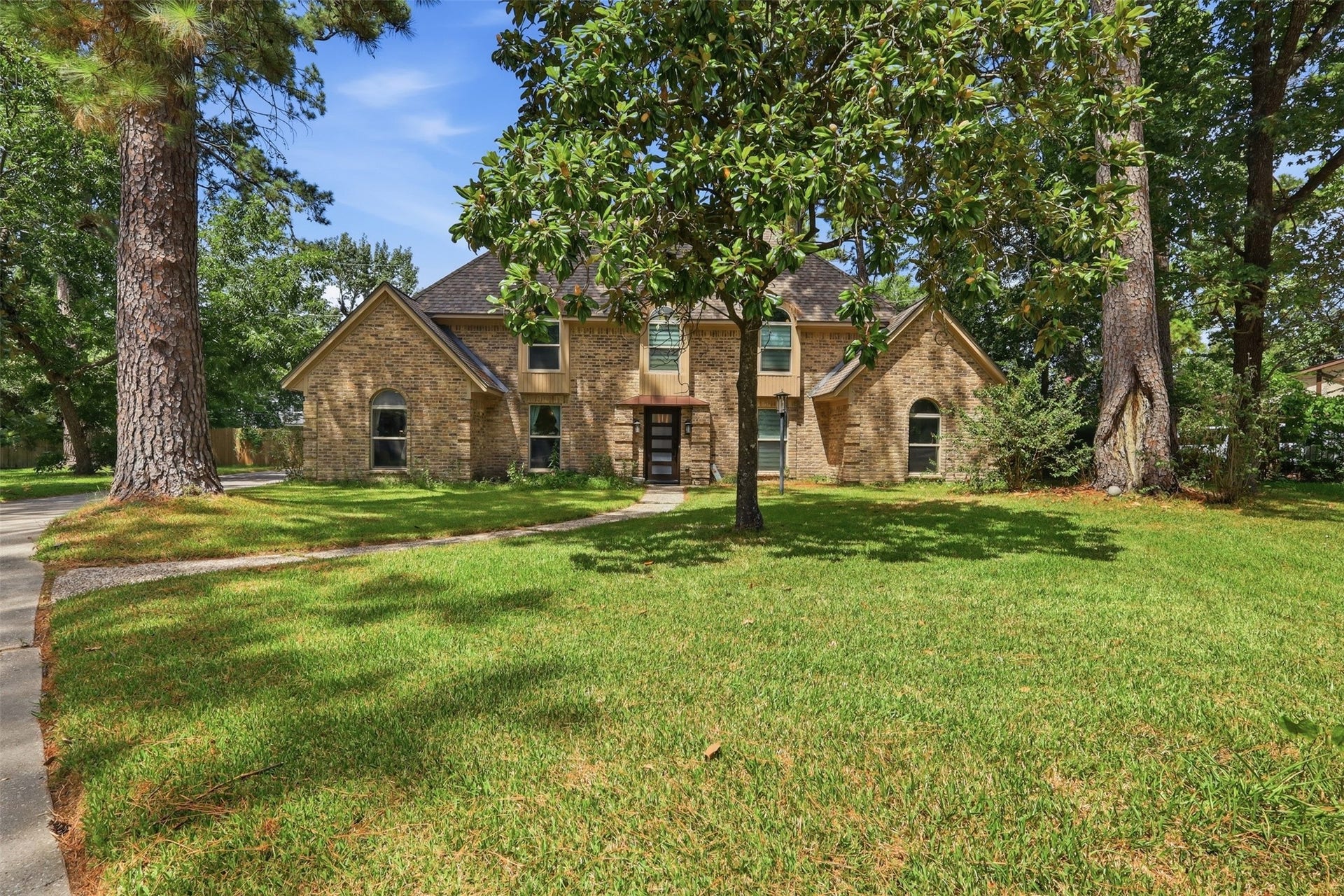 6518 Elmgrove Road, Spring, TX 77389 Beautifully shaded by mature trees, this stately brick home sits on an expansive lot with impressive curb appeal.