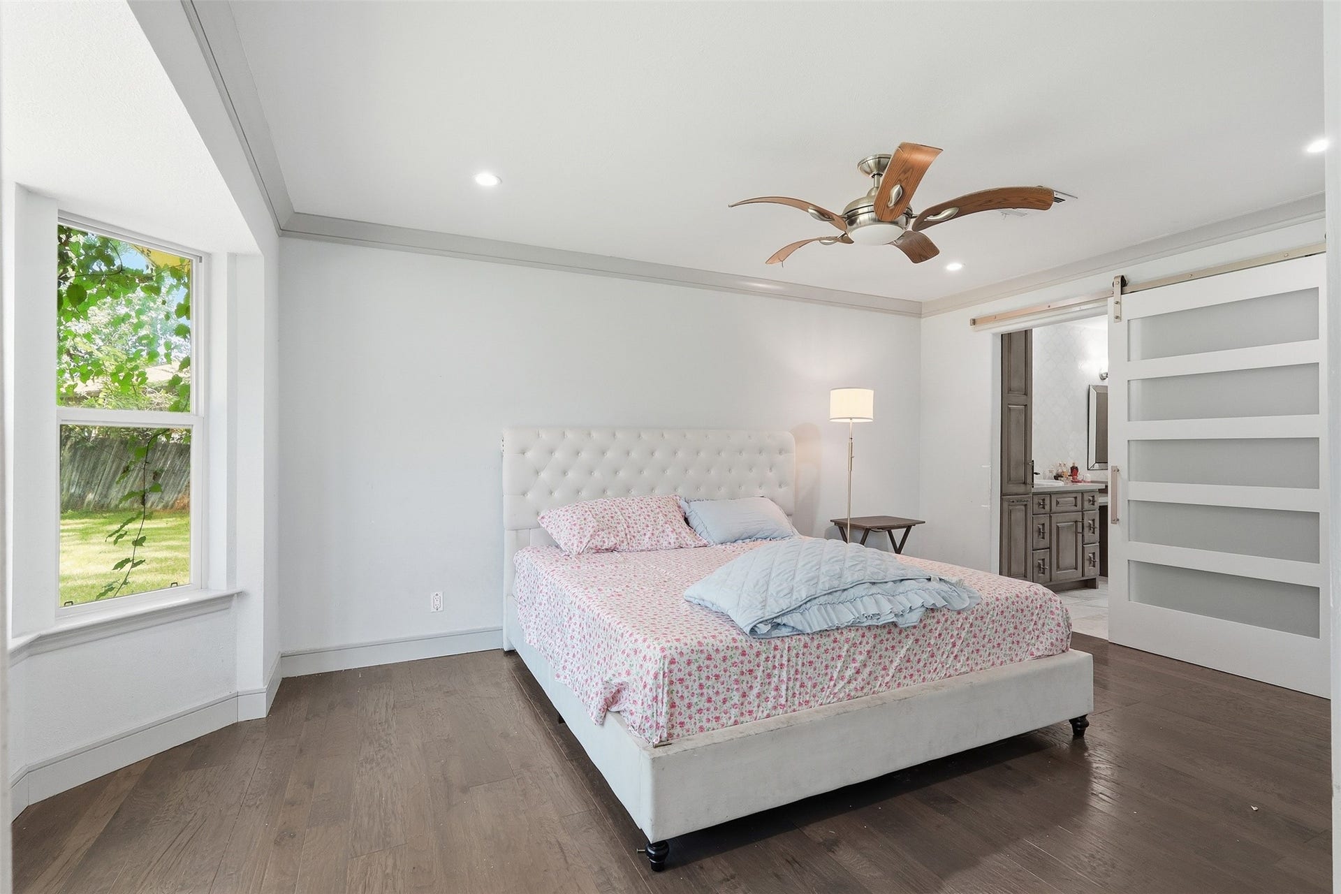 6518 Elmgrove Road, Spring, TX 77389 Spacious primary suite with hardwood floors, abundant natural light, and private access to the en suite bath.