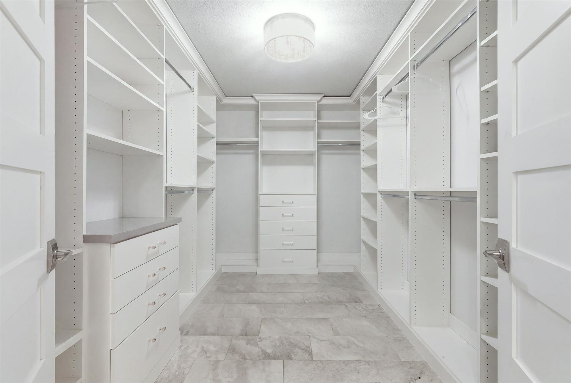 6518 Elmgrove Road, Spring, TX 77389 Dream-worthy walk-in closet with custom built-ins, abundant shelving, hanging space, and drawer storage.