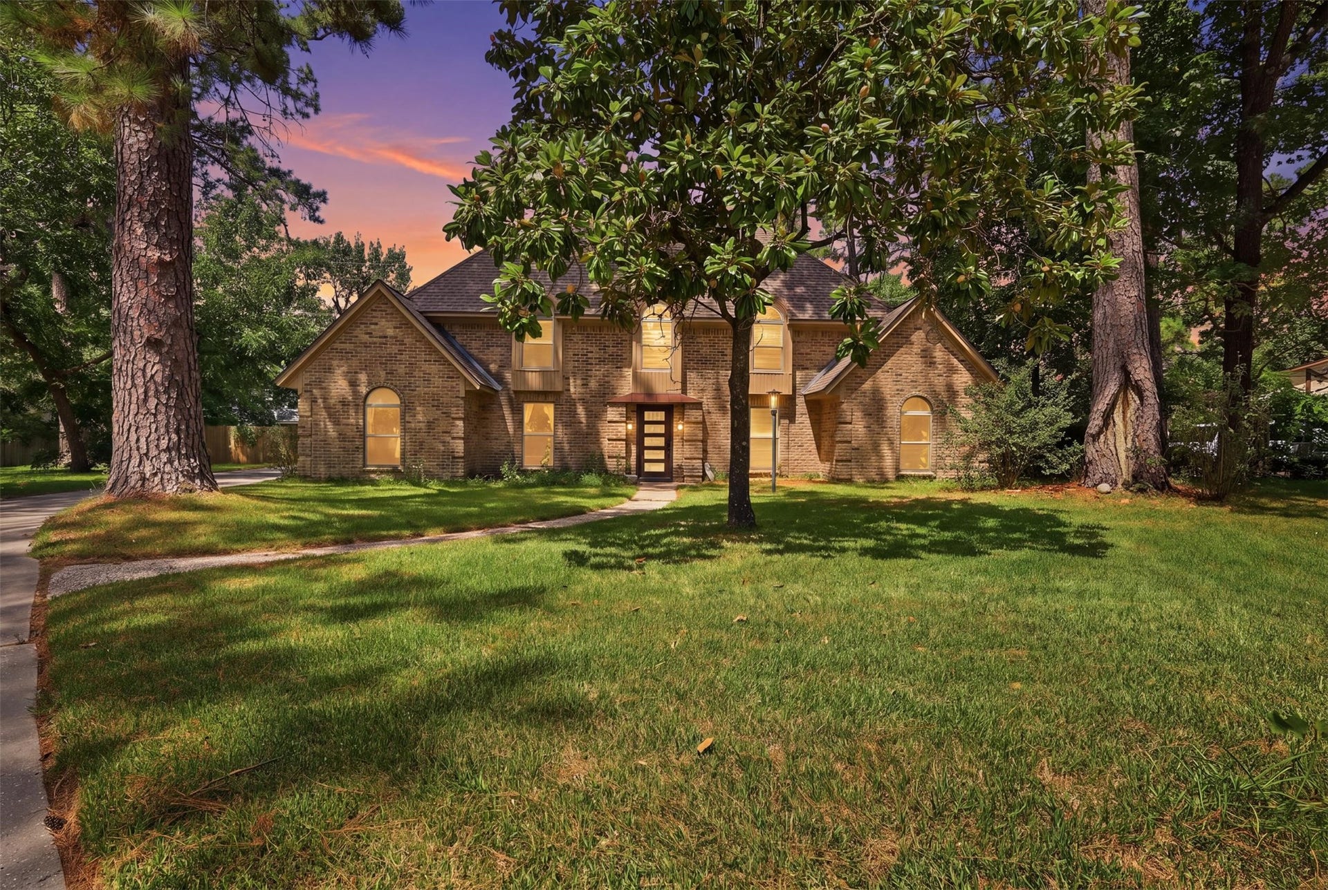 6518 Elmgrove Road, Spring, TX 77389 Stately brick home nestled beneath mature trees, offering timeless curb appeal and a beautiful sense of arrival.