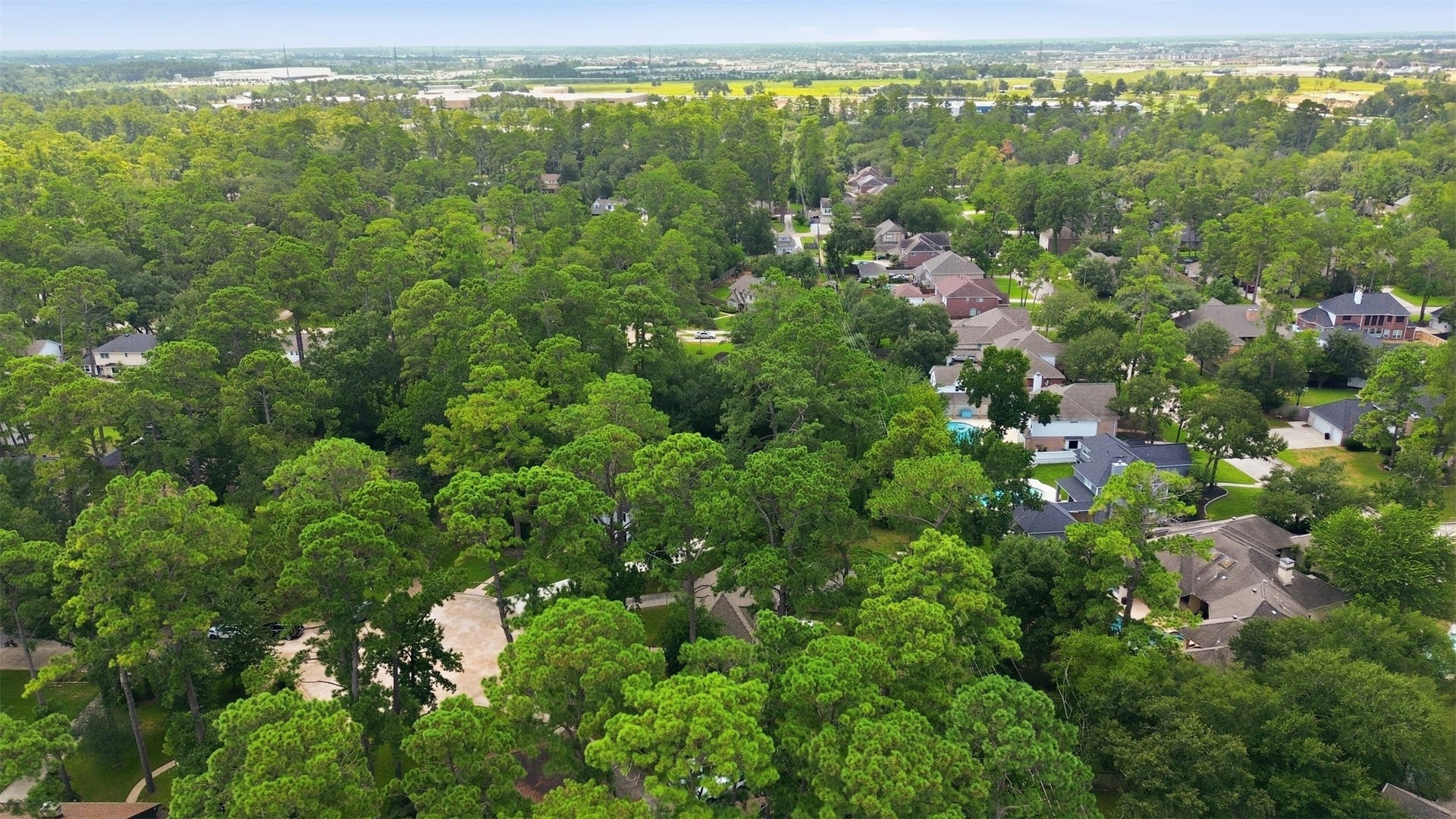 6518 Elmgrove Road, Spring, TX 77389 Aerial view showcasing the peaceful, tree-lined neighborhood and beautifully established surroundings.