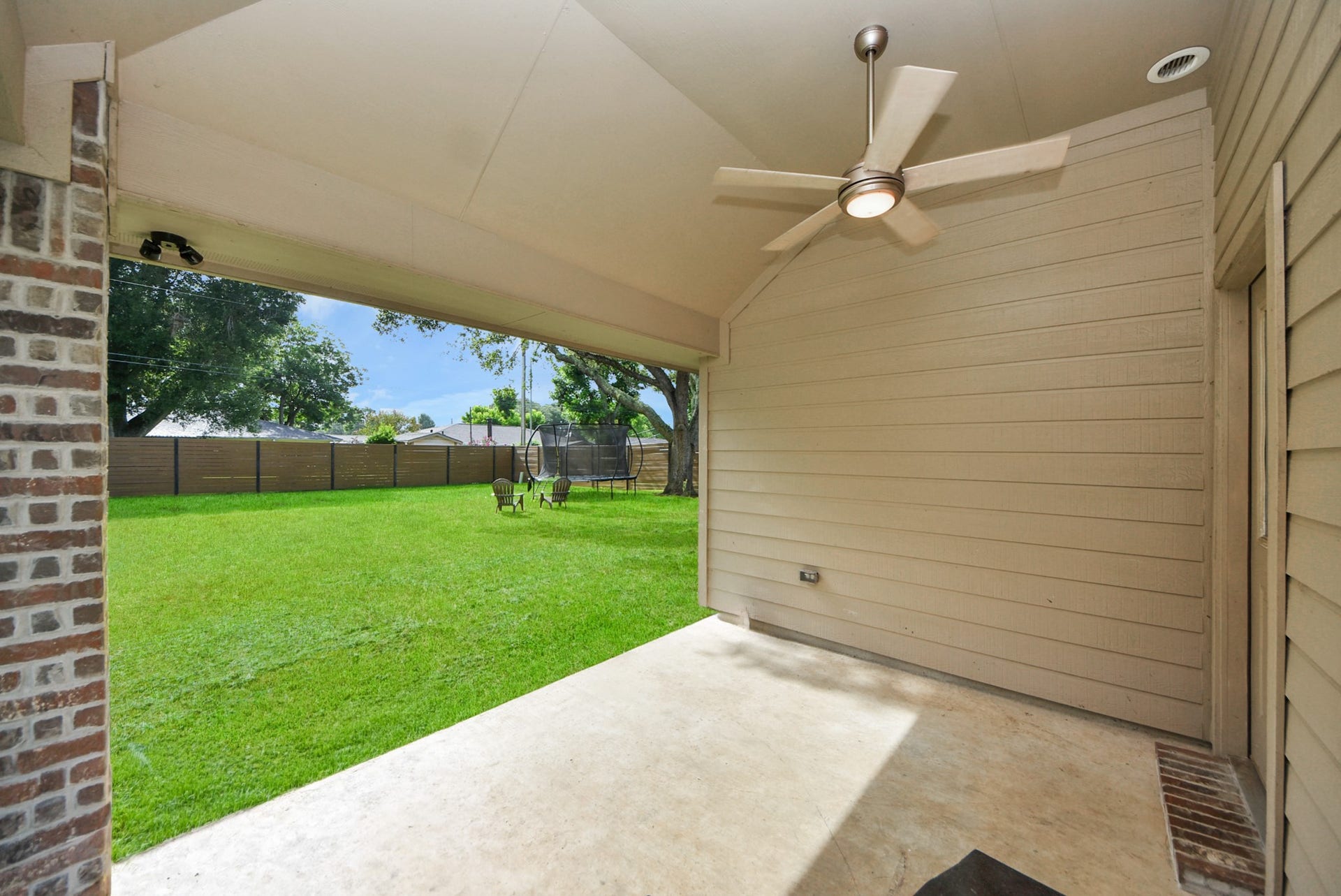 1023 S Anderson Street, Angleton, TX 77515 Covered back patio offering a comfortable space for outdoor relaxation