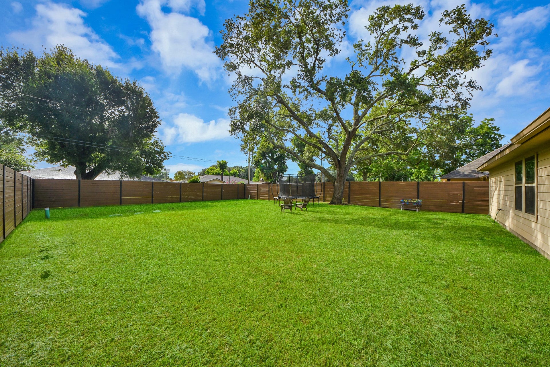 1023 S Anderson Street, Angleton, TX 77515 Spacious backyard offering plenty of potential for outdoor entertaining