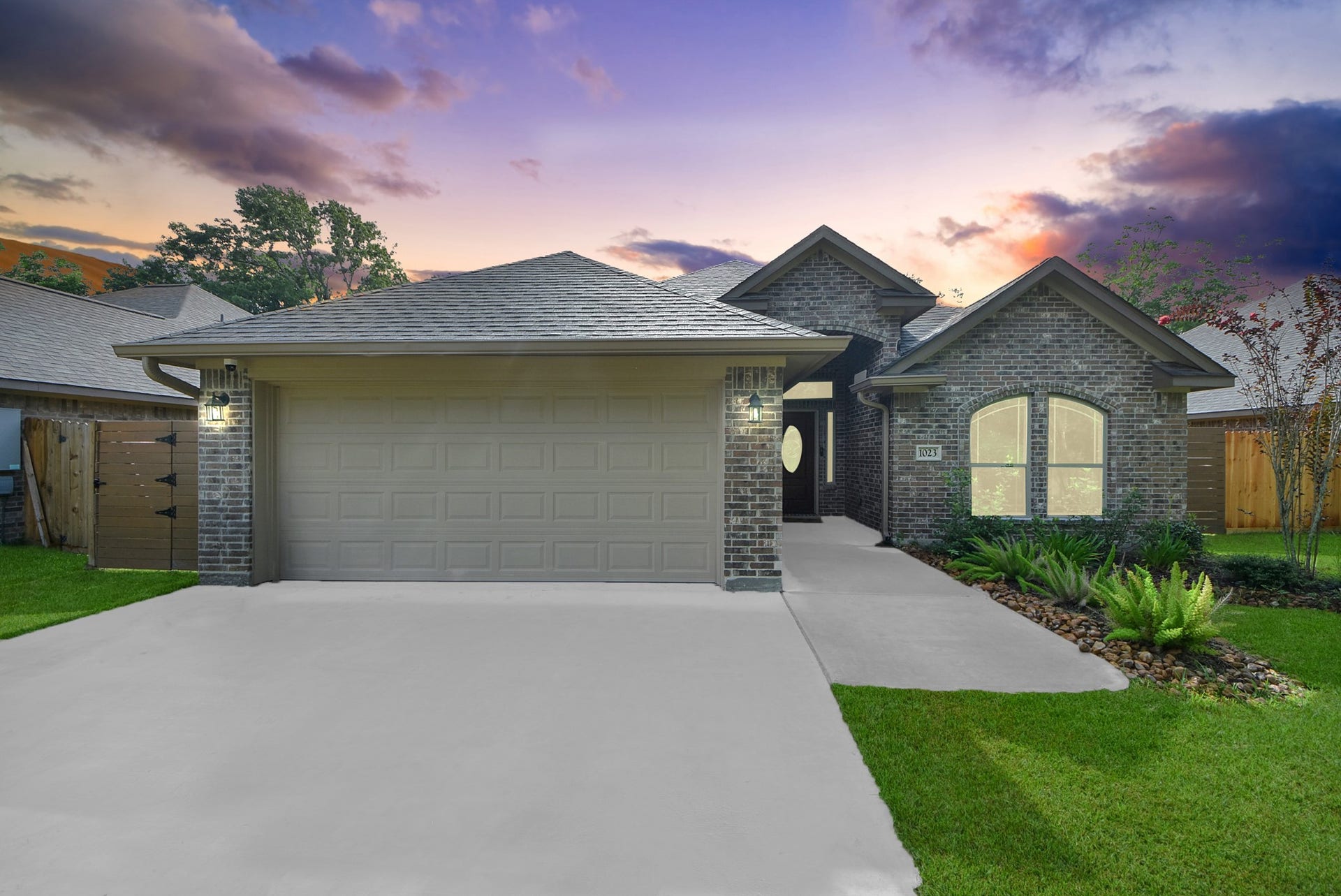 1023 S Anderson Street, Angleton, TX 77515 Beautiful twilight view showcasing the home's modern exterior and inviting curb appeal