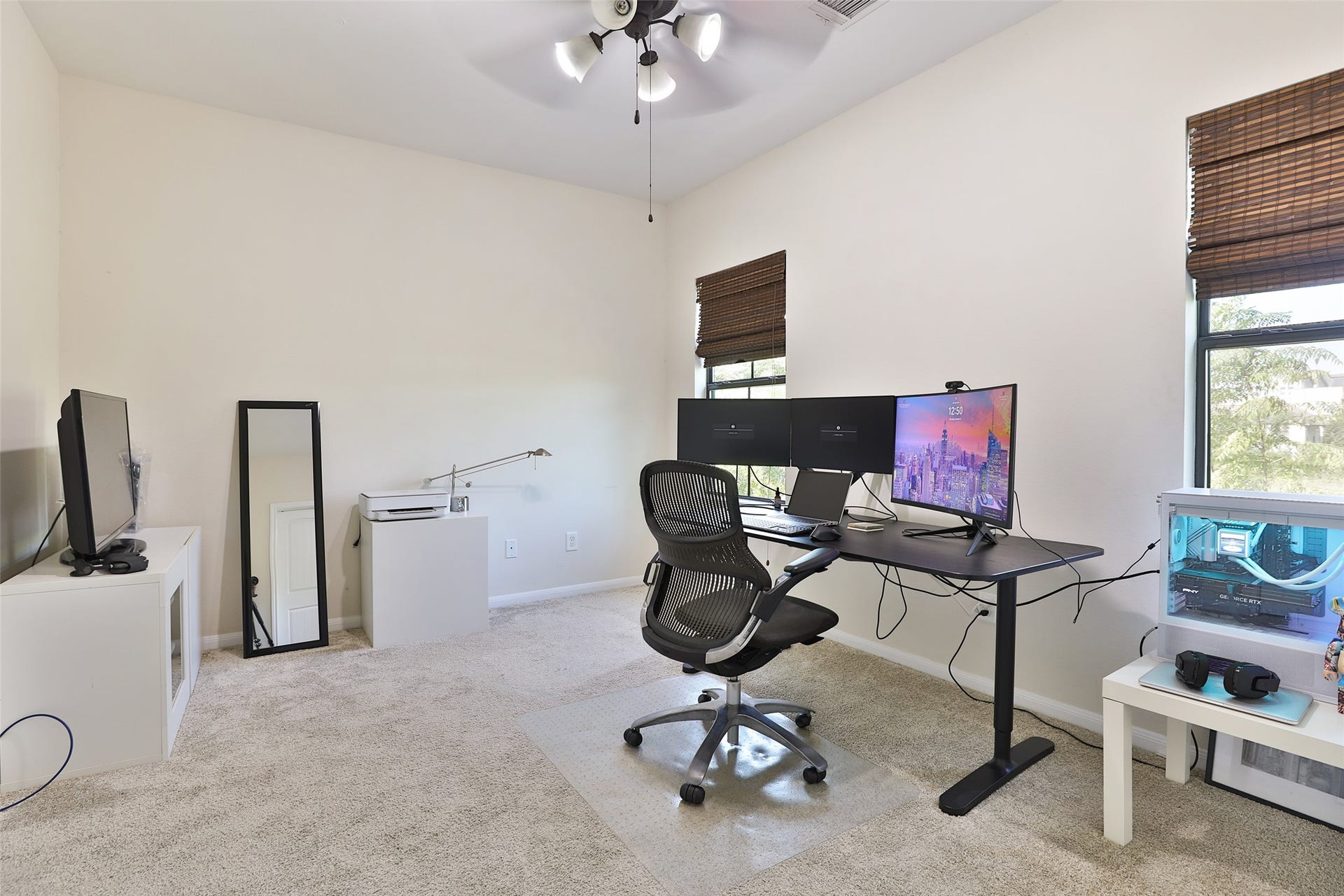 1112 Bingham Street, Houston, TX 77007 Spacious home office with natural light, featuring modern dual-monitor setup, comfortable chair, and stylish decor.