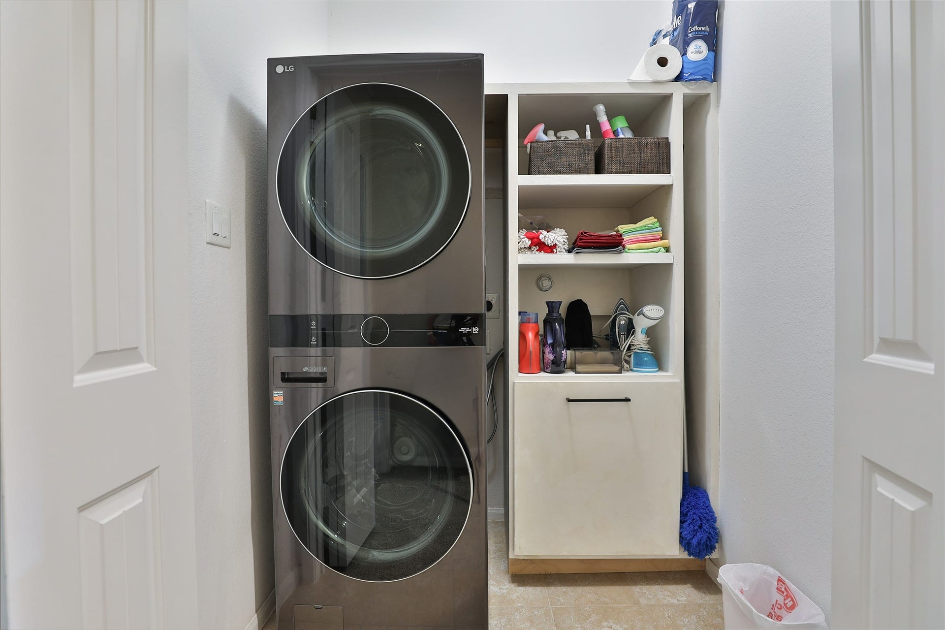 1112 Bingham Street, Houston, TX 77007 Modern laundry space featuring a sleek stacked washer and dryer alongside organized shelving for storage.