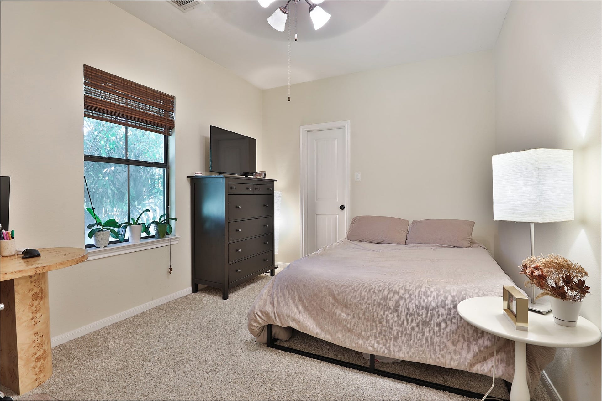 1112 Bingham Street, Houston, TX 77007 Cozy bedroom featuring soft carpeting, a comfortable bed, and abundant natural light from a large window.