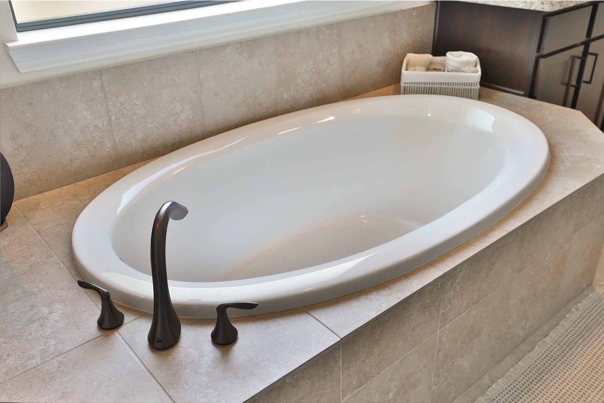 1112 Bingham Street, Houston, TX 77007 Luxurious oval soaking tub set in elegant tile with sleek fixtures, offering a serene retreat in the bathroom.