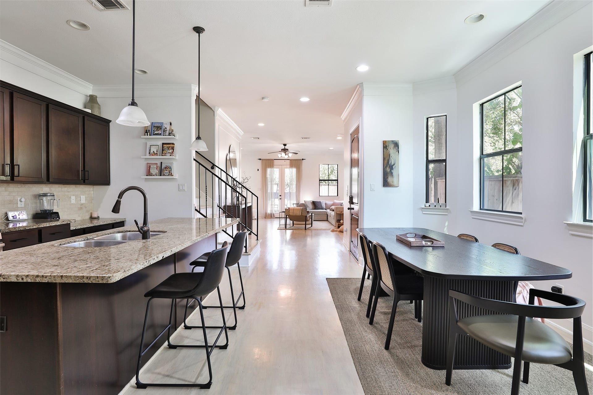 1112 Bingham Street, Houston, TX 77007 Elegant open-concept living space featuring a modern kitchen with granite countertops, a spacious dining area, and ample natural light flowing through large windows.