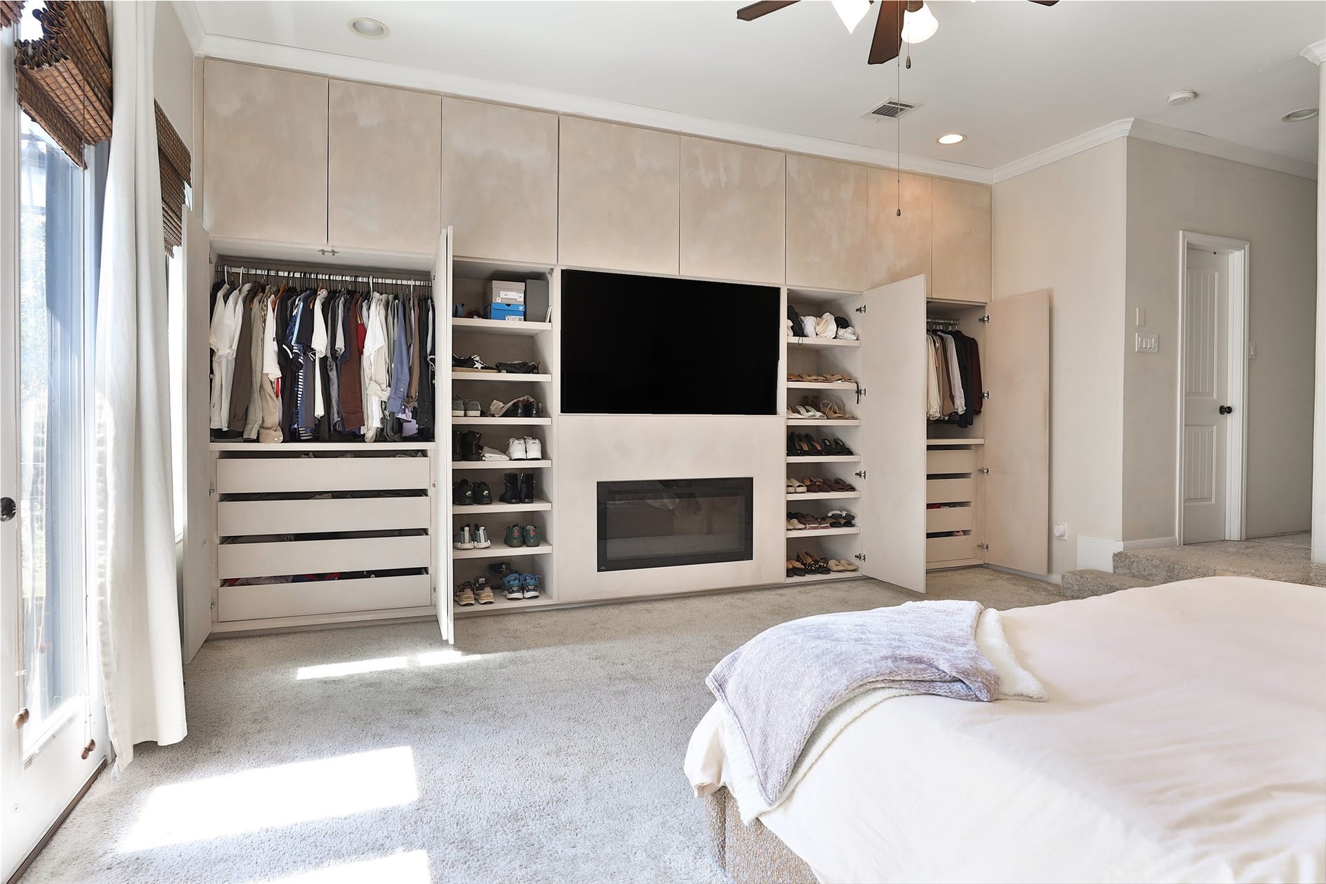 1112 Bingham Street, Houston, TX 77007 Spacious bedroom with built-in storage, featuring a sleek entertainment center, organized closets, and abundant natural light.
