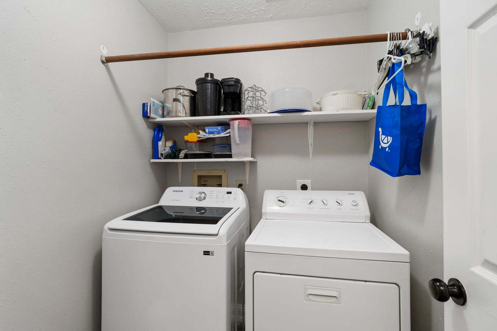 2437 Willow Bend Drive, Richmond, TX 77406 Laundry room inside featuring open shelving for storage and a convenient hanging rod.