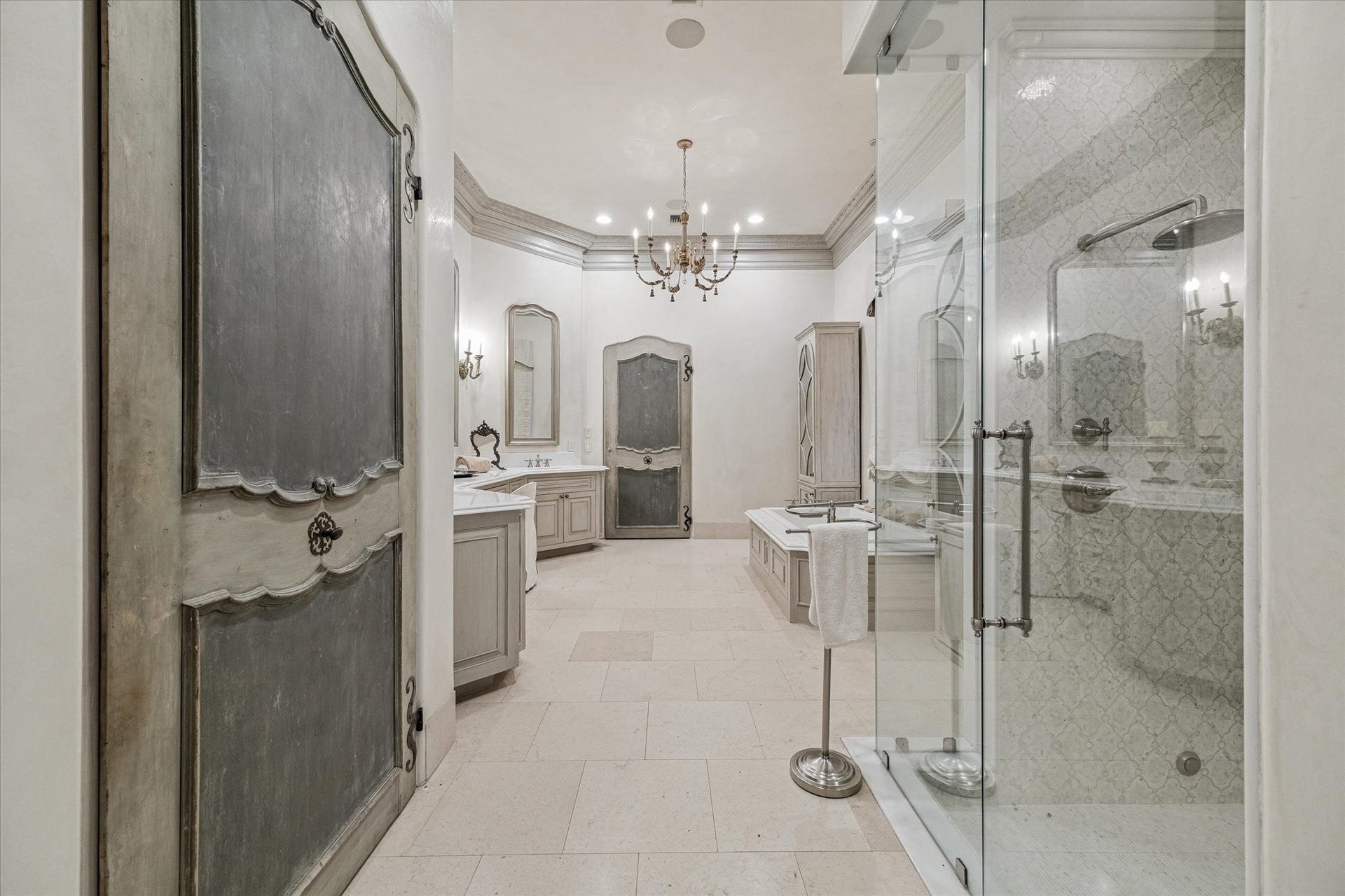Beautiful master bathroom with imported Italian doors, and marble and limestone throughout.