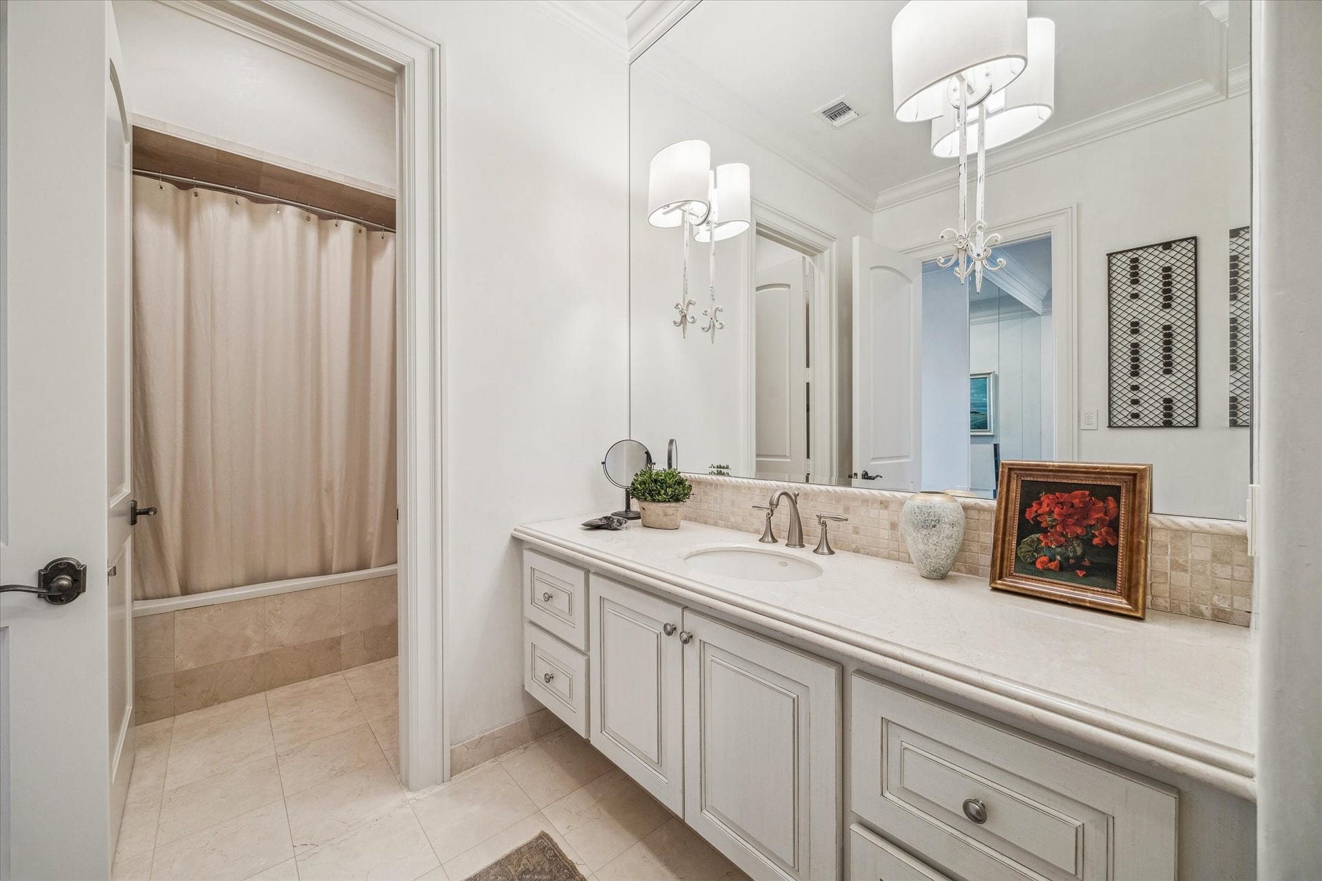 Secondary bathroom featuring a spacious vanity, tub/shower combination, and clean, classic finishes.