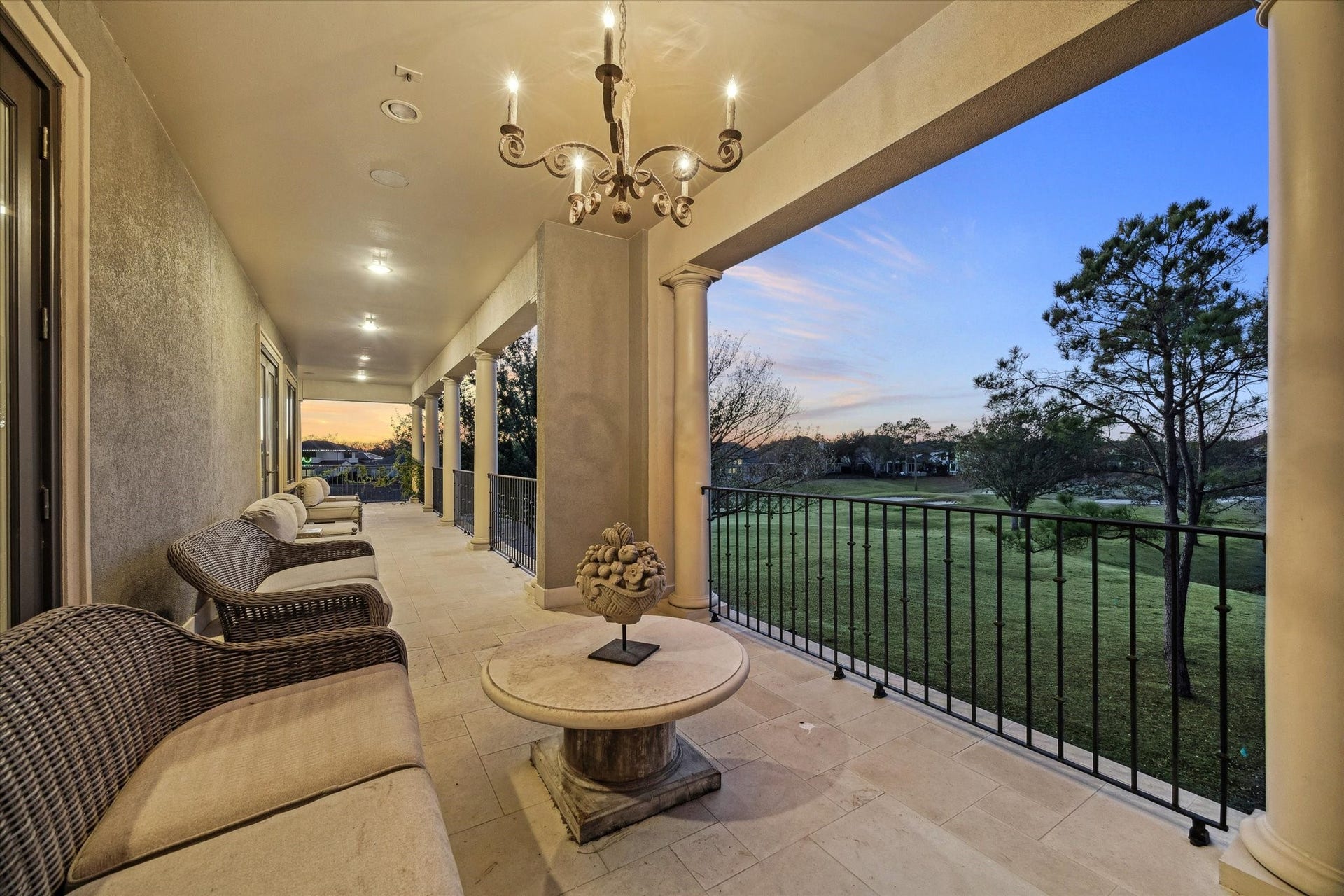 Upper-level covered balcony with sweeping views of the golf course.