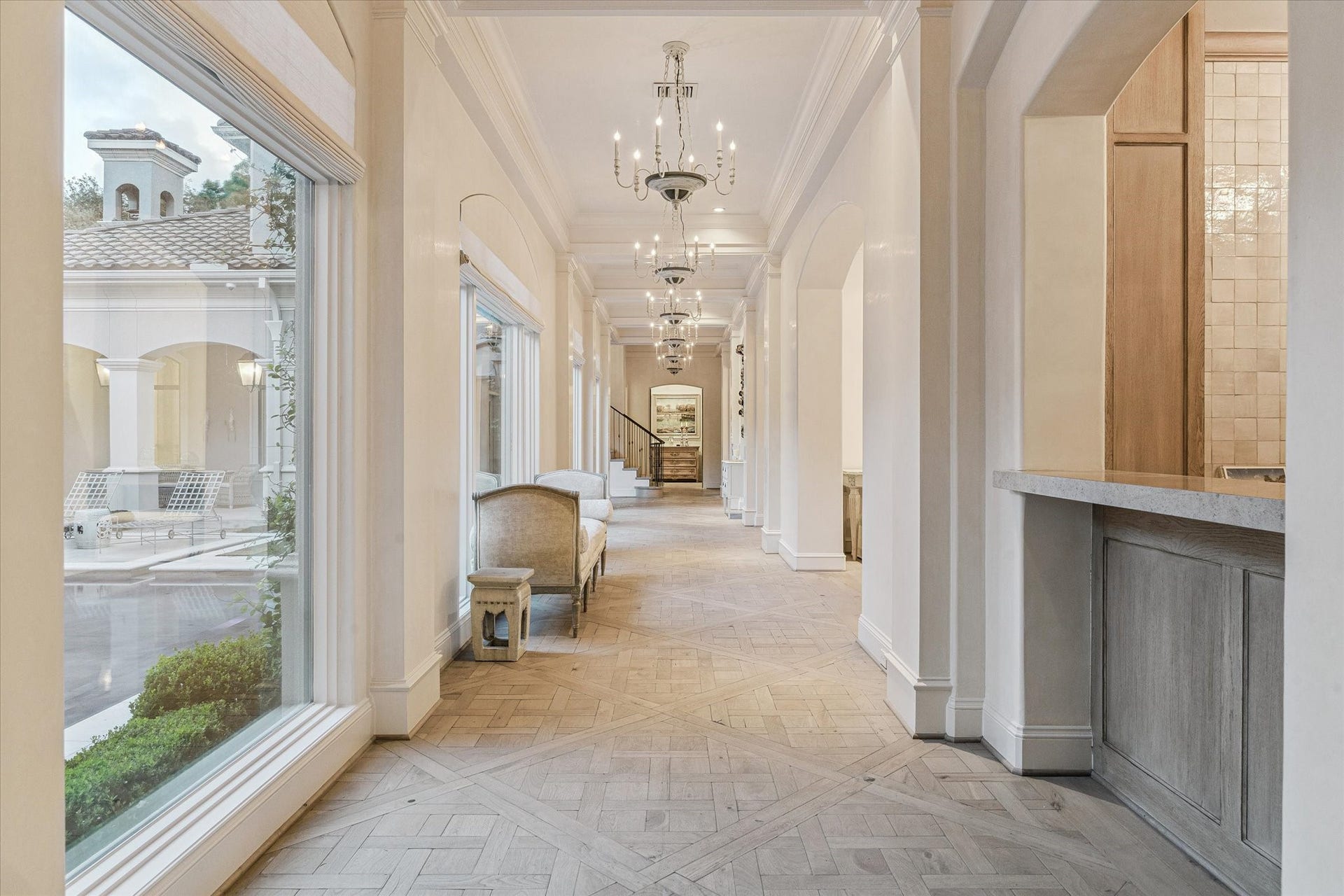 Another view of this breathtaking gallery surrounding the courtyard and connecting each room. Imagine walking with a view of the serene courtyard on one side and the golf course to the other side.