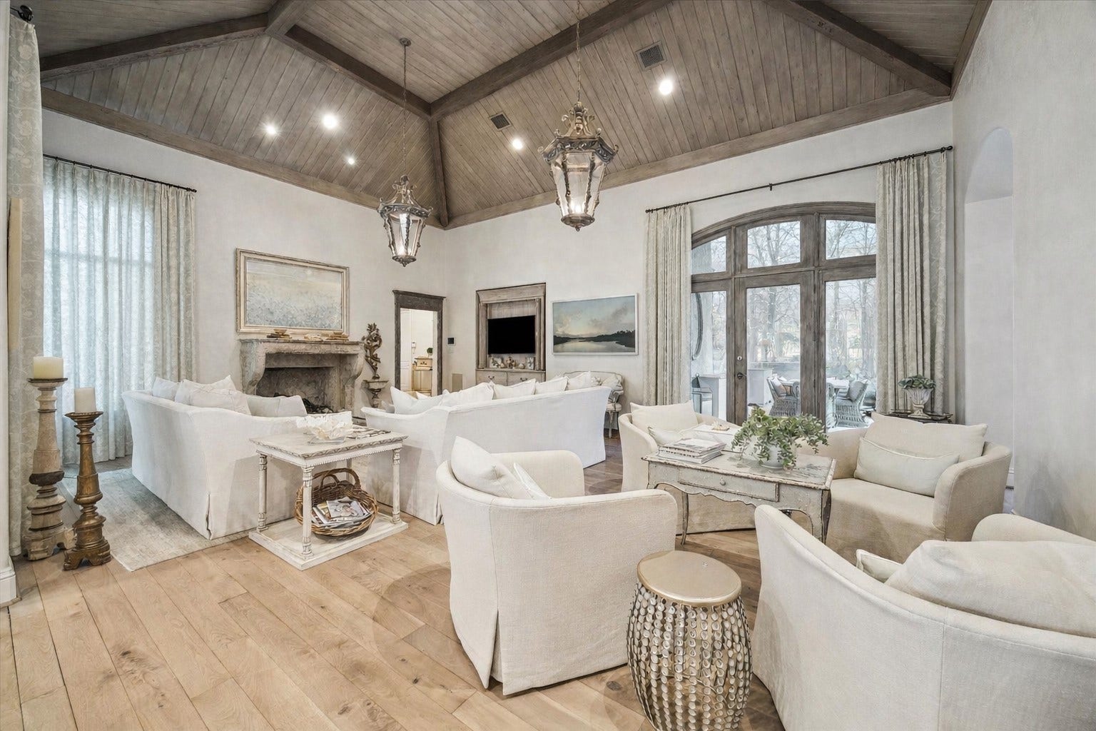 Gorgeous Den off the kitchen and outdoor living area. Reclaimed antique beams and ceiling, wood flooring, mid century imported fireplace and hallway surrounds with Segreto plastered walls.