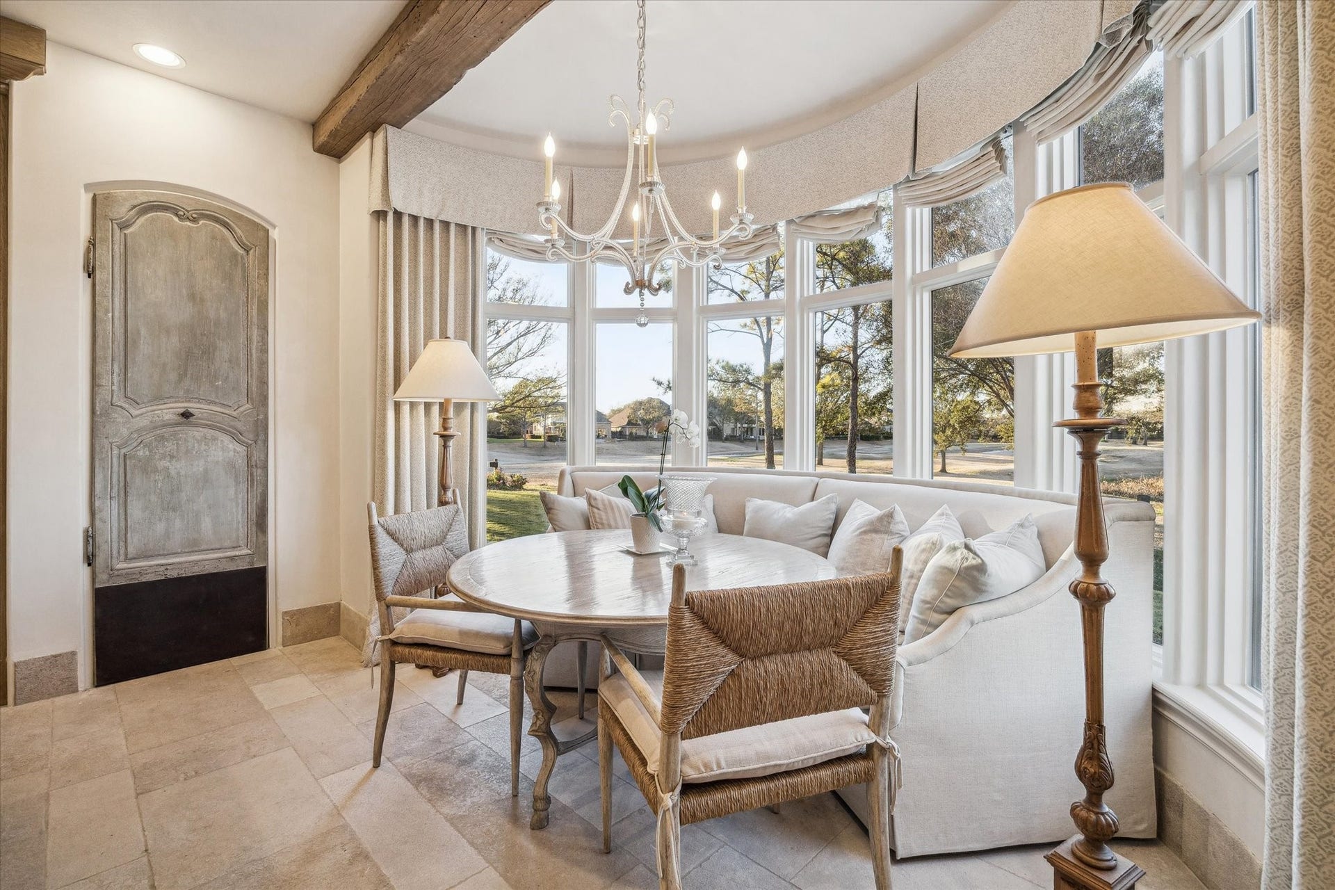 Breakfast room overlooking the golf course, large windows, and abundant natural light with views.
