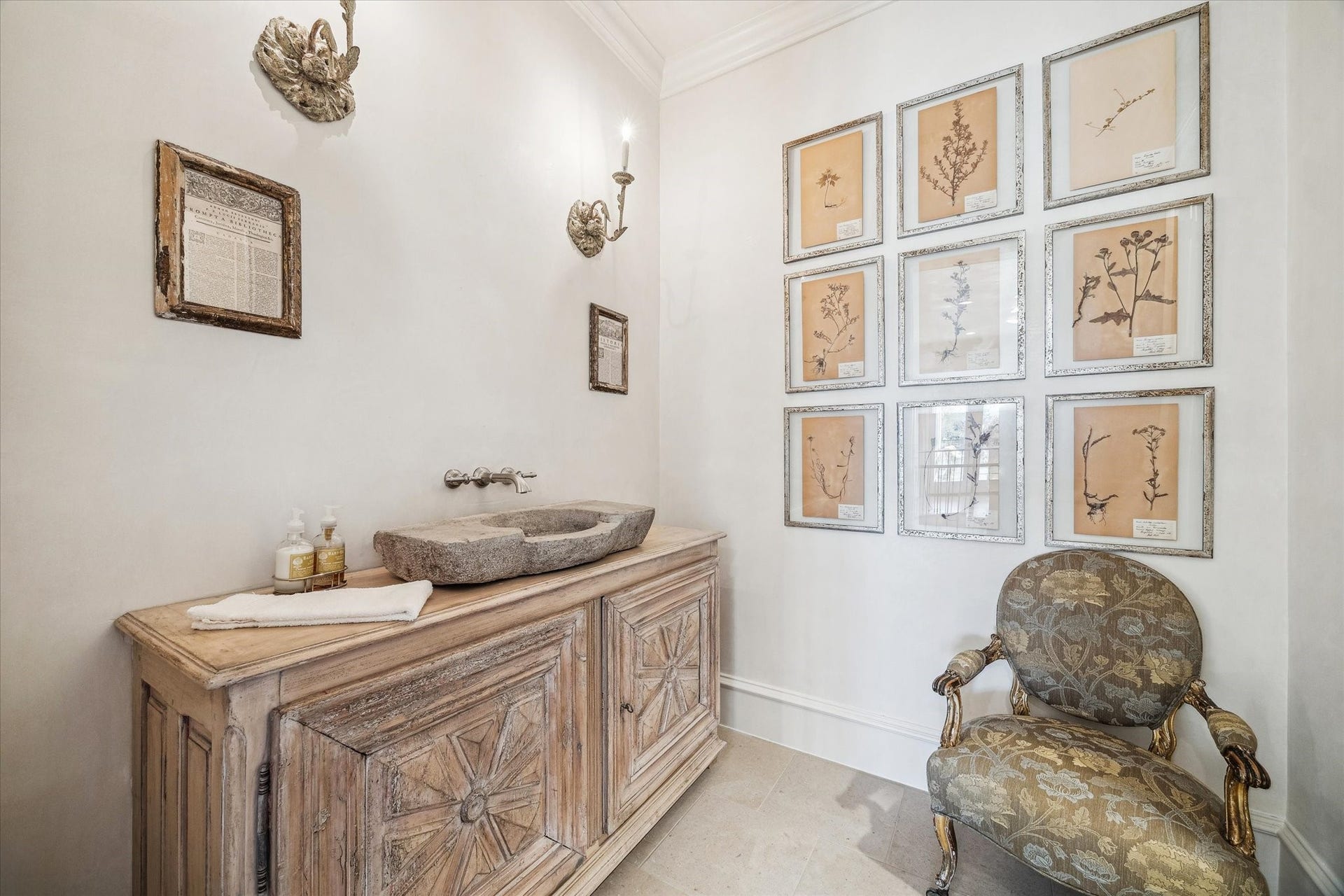 Upstairs powder bath off the game room featuring a custom vanity, stone vessel sink, and designer lighting.