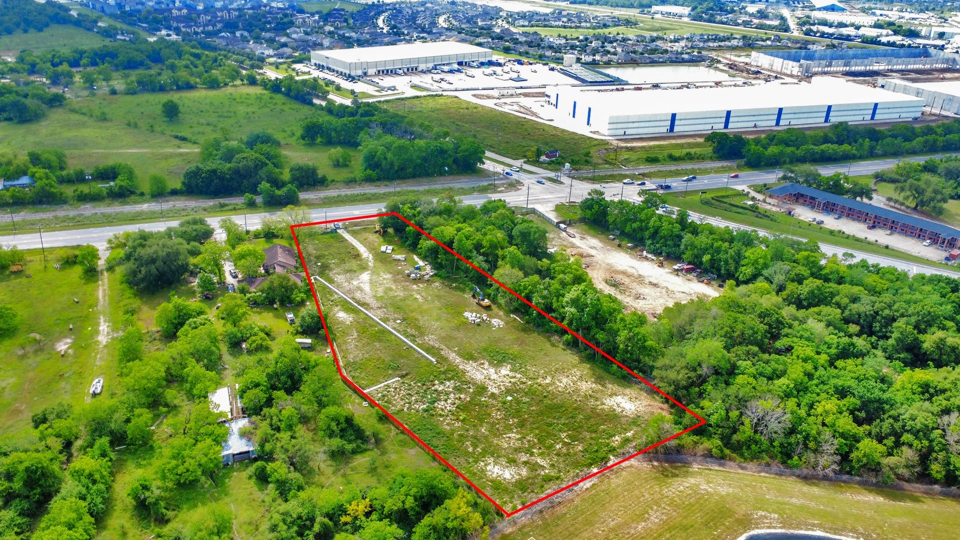 11826 Almeda Road, Houston, TX 77045 Spacious plot of land outlined in red, located near a main road. Surrounded by lush greenery and adjacent to commercial and residential areas. Ideal for development with convenient access to nearby amenities.