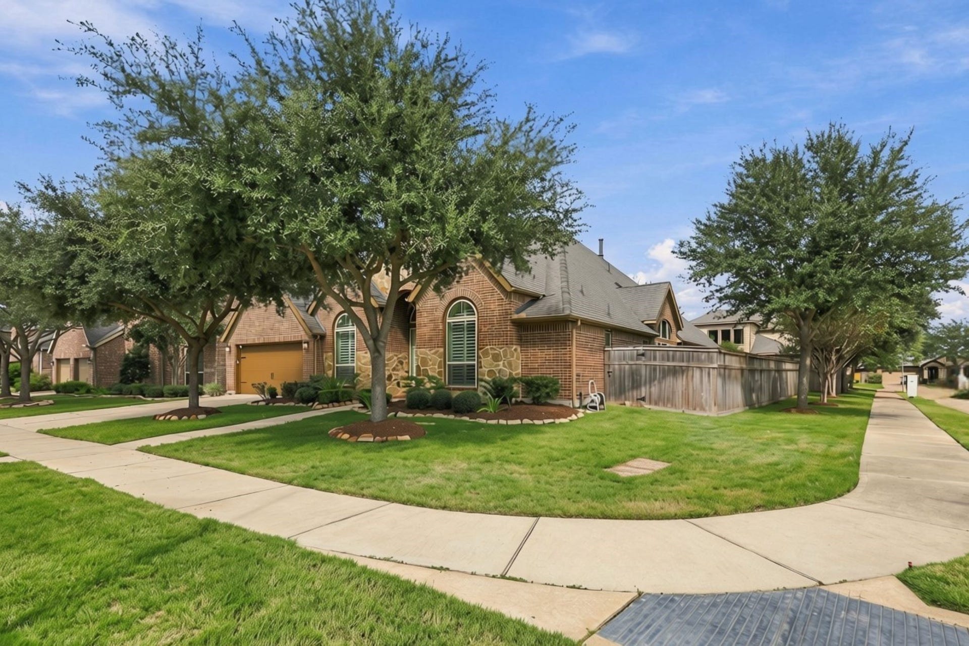 27302 Liberty Heights Lane, Fulshear, TX 77441 The side yard offers additional outdoor space, and the community mailboxes are conveniently located just down the sidewalk for easy access.