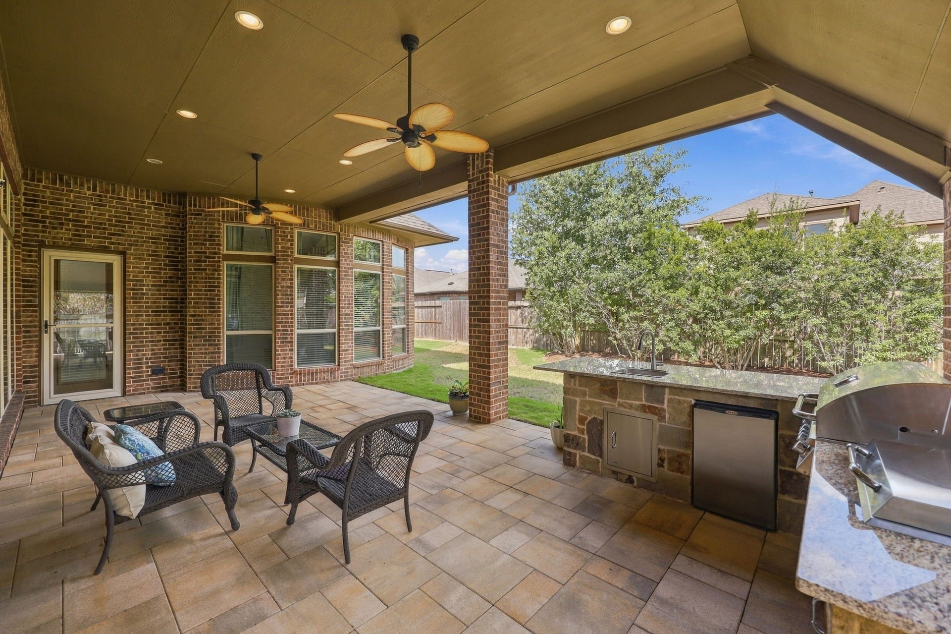 27302 Liberty Heights Lane, Fulshear, TX 77441 This view looks out toward the Backyard, where mature landscaping provides added privacy and creates a peaceful outdoor setting. The low-maintenance yard is easy to care for, allowing you to spend more time relaxing and enjoying your outdoor living space.