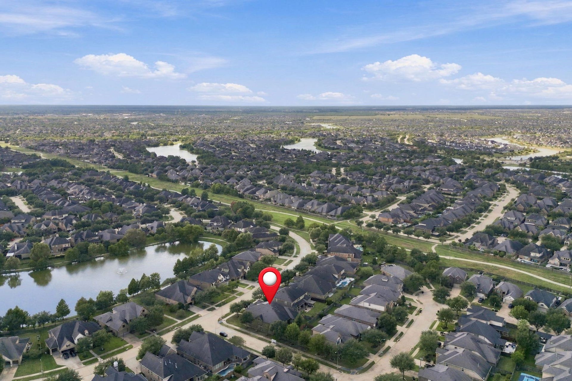 27302 Liberty Heights Lane, Fulshear, TX 77441 This additional aerial view pinpoints the home's location within Cross Creek Ranch, highlighting its convenient setting near neighborhood lakes, walking trails, schools, and shopping.