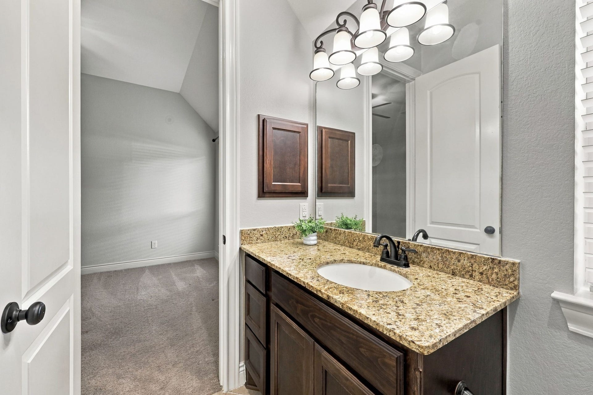 27302 Liberty Heights Lane, Fulshear, TX 77441 This closer look at the vanity area highlights the Full Bathroom shared by Bedrooms #2 and #3. Features include an undermount sink, a convenient medicine cabinet, and beautiful espresso cabinetry and drawer storage, combining style and functionality.