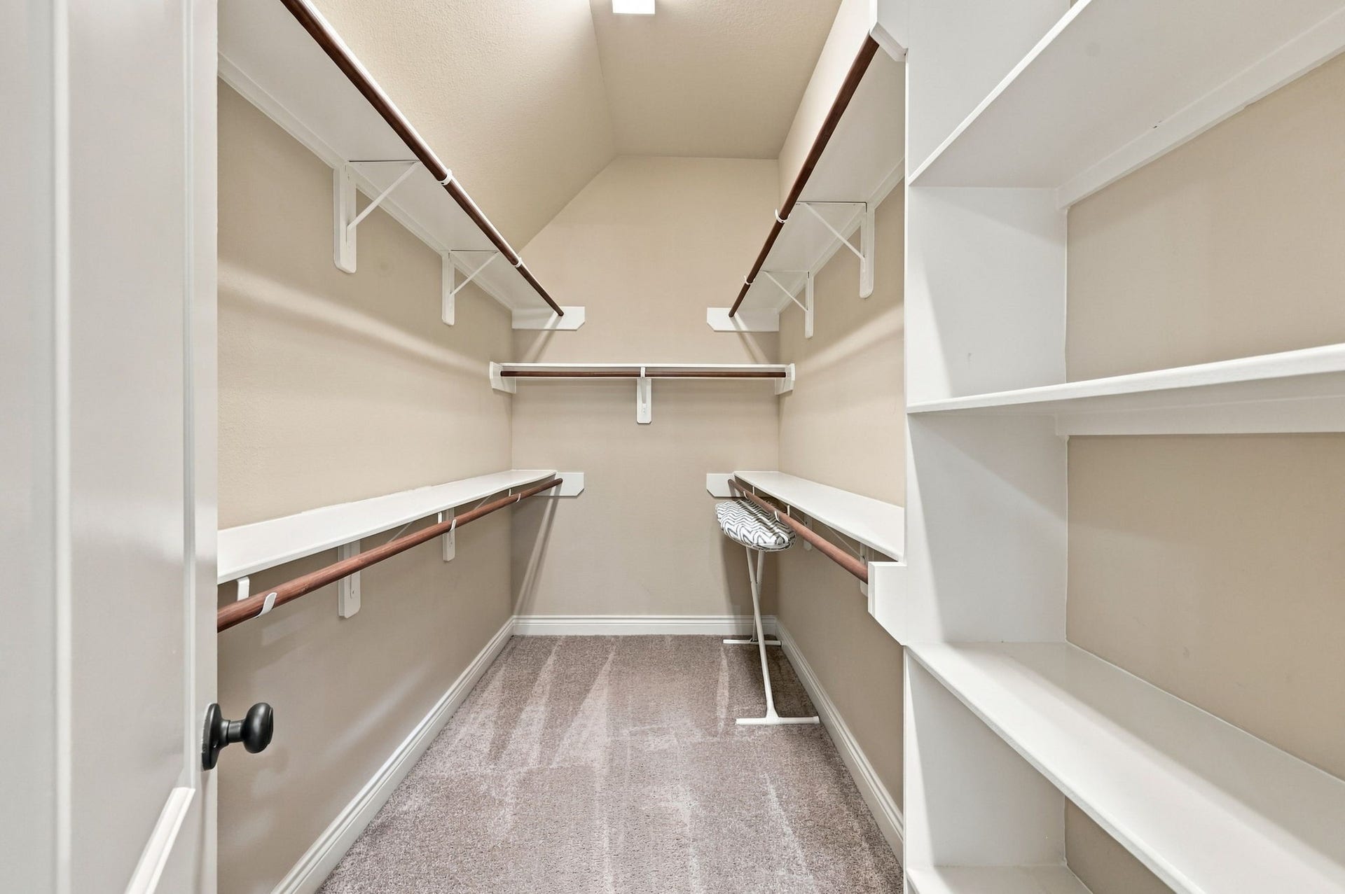 27302 Liberty Heights Lane, Fulshear, TX 77441 The Primary Bathroom offers two separate walk-in closets for added storage and organization. This spacious closet is one of the two, providing plenty of room for clothing, shoes, and accessories.
