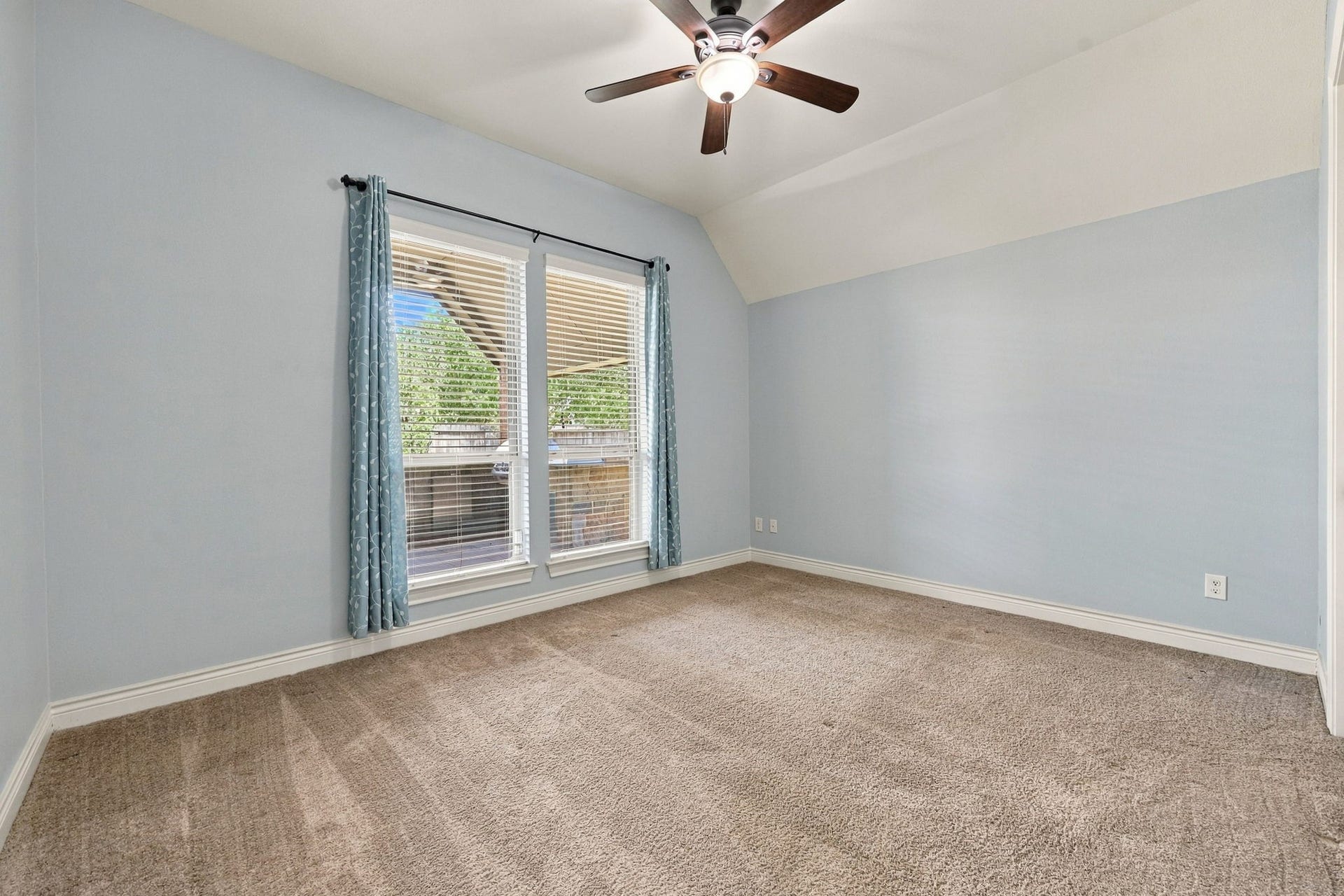 27302 Liberty Heights Lane, Fulshear, TX 77441 Bedroom #4 is located toward the back of the home and offers access to a Full Bathroom. This generously sized Bedroom features two large windows dressed with custom draperies, wall-to-wall carpeting, and a spacious walk-in closet. Enjoy peaceful views of the private covered Back Patio, making this room a comfortable and inviting retreat for family members or guests.