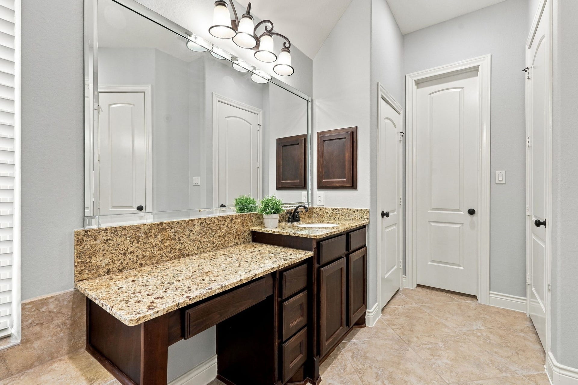 27302 Liberty Heights Lane, Fulshear, TX 77441 This vanity area offers additional space to sit and comfortably apply makeup, adding a touch of convenience to your daily routine. The doors in the distance lead to the second walk-in closet and a separate linen closet, providing additional storage and organization.