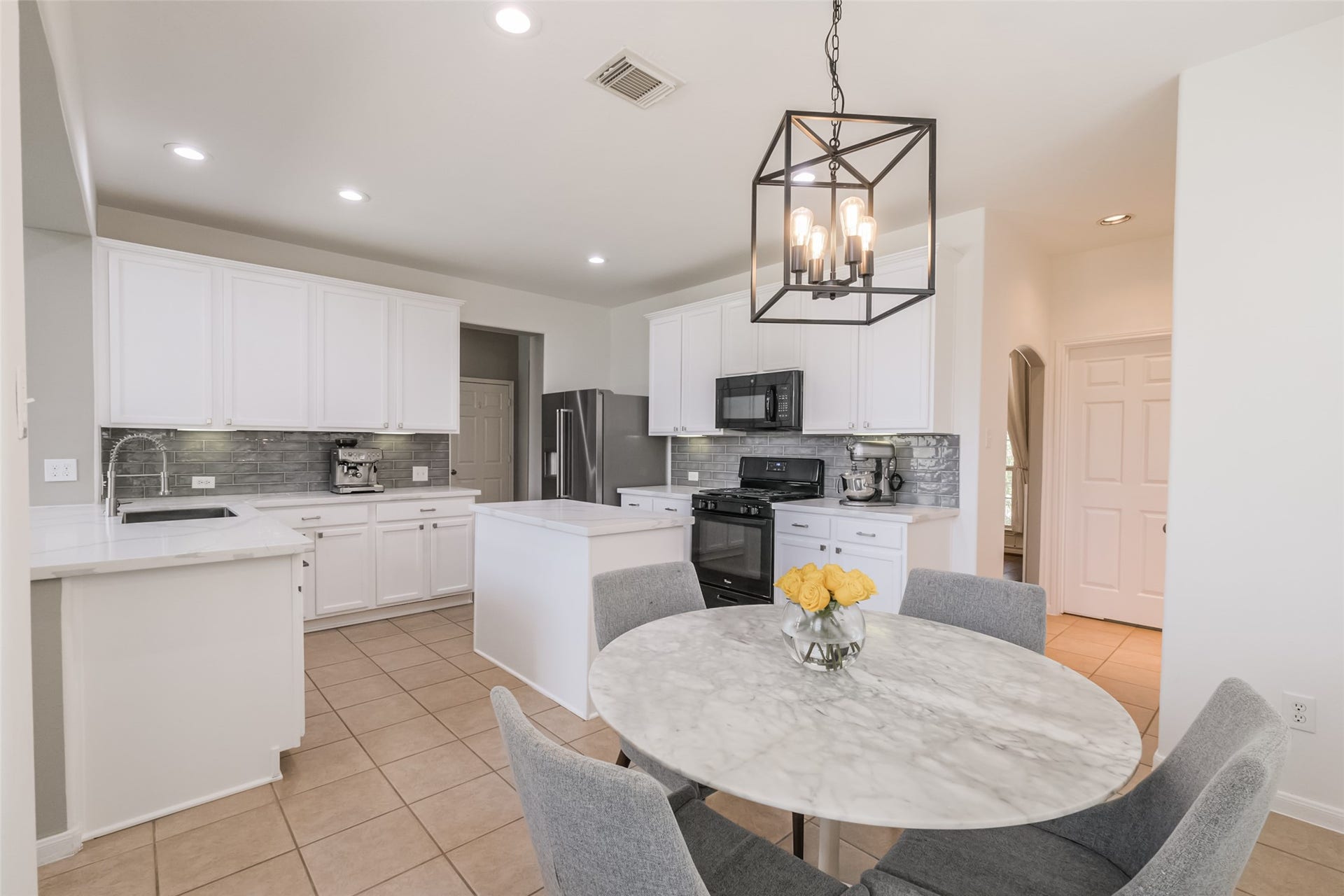 10314 Five Oaks Crossing, Missouri City, TX 77459 This photo showcases a modern kitchen with white cabinetry.
