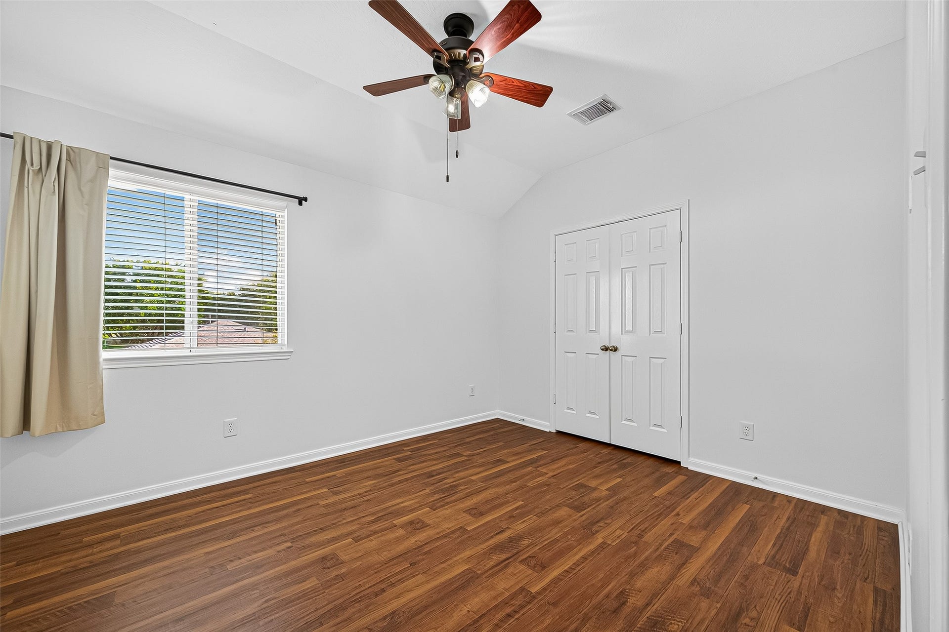 10314 Five Oaks Crossing, Missouri City, TX 77459 Bright and cozy bedroom 4 with a ceiling fan, featuring a large window, and NEW FLOORING!