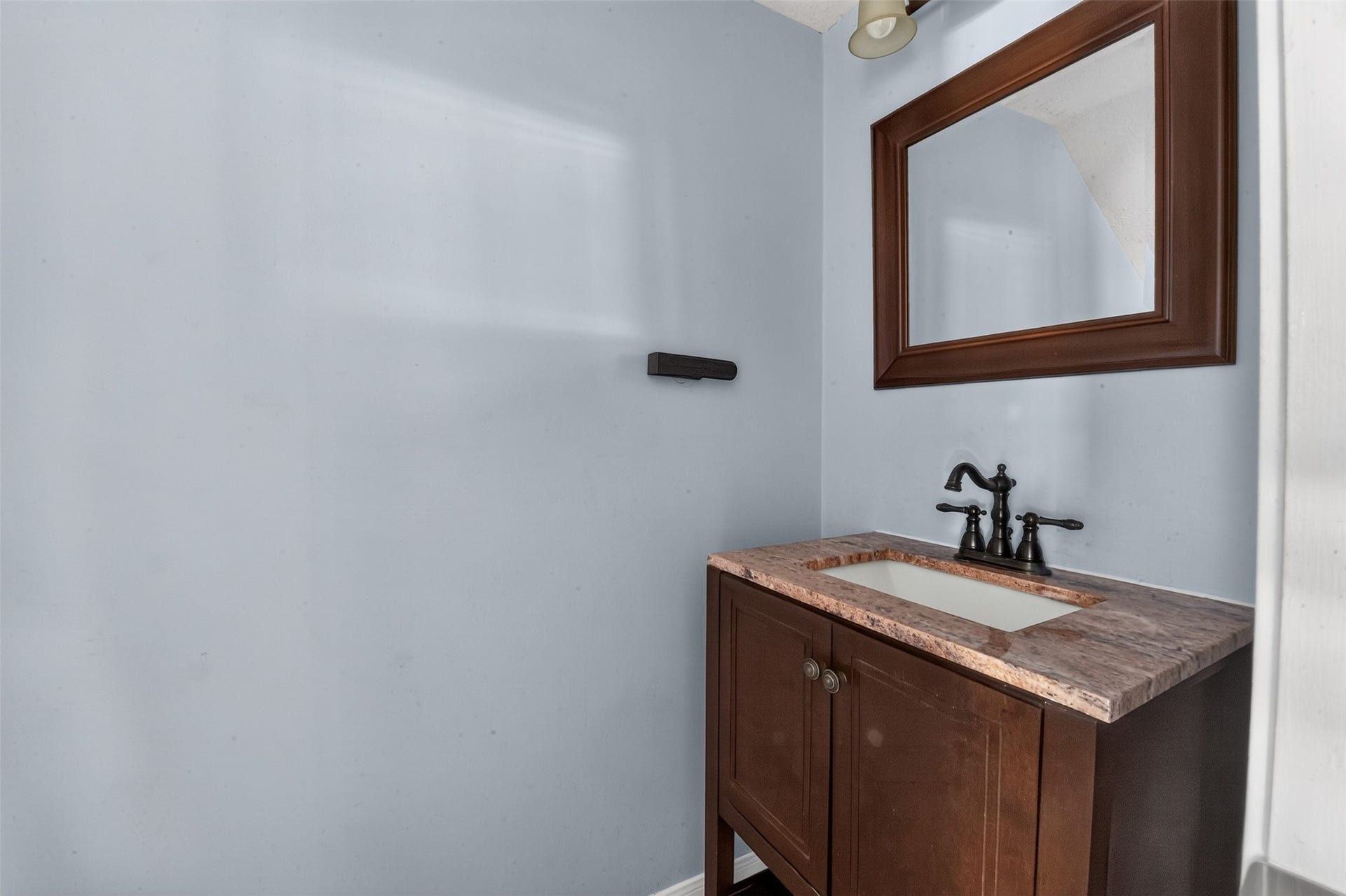 Half bath between the kitchen and dining room.