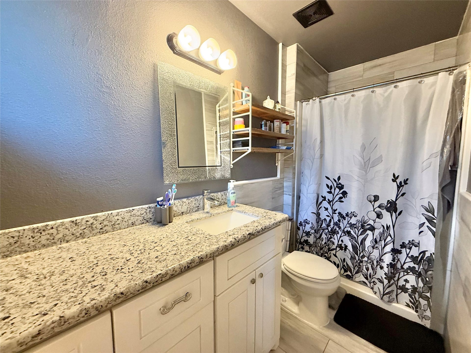 2133 Greenlee Lane, Dickinson, TX 77539 En-suite Bathroom with granite counters and floor to ceiling tile in shower and wainscoting the walls