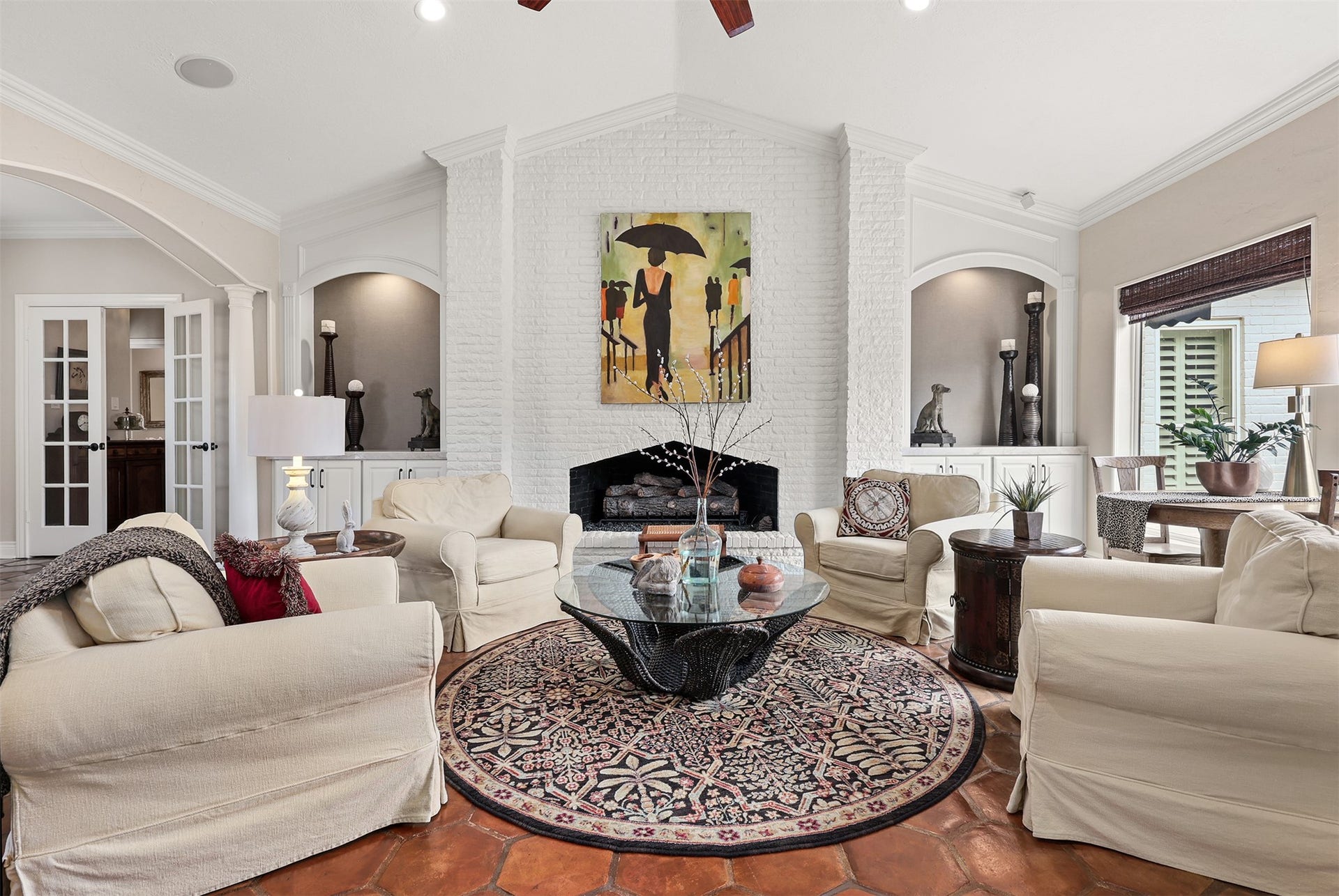 18607 Point Lookout Drive, Nassau Bay, TX 77058 A stunning floor-to-ceiling painted brick fireplace serves as the focal point of this beautiful living space, featuring an impressive four-foot custom size gas log set. Flanked by graceful arched niches and custom cabinetry, this striking fireplace adds timeless character and warmth to the heart of the home.