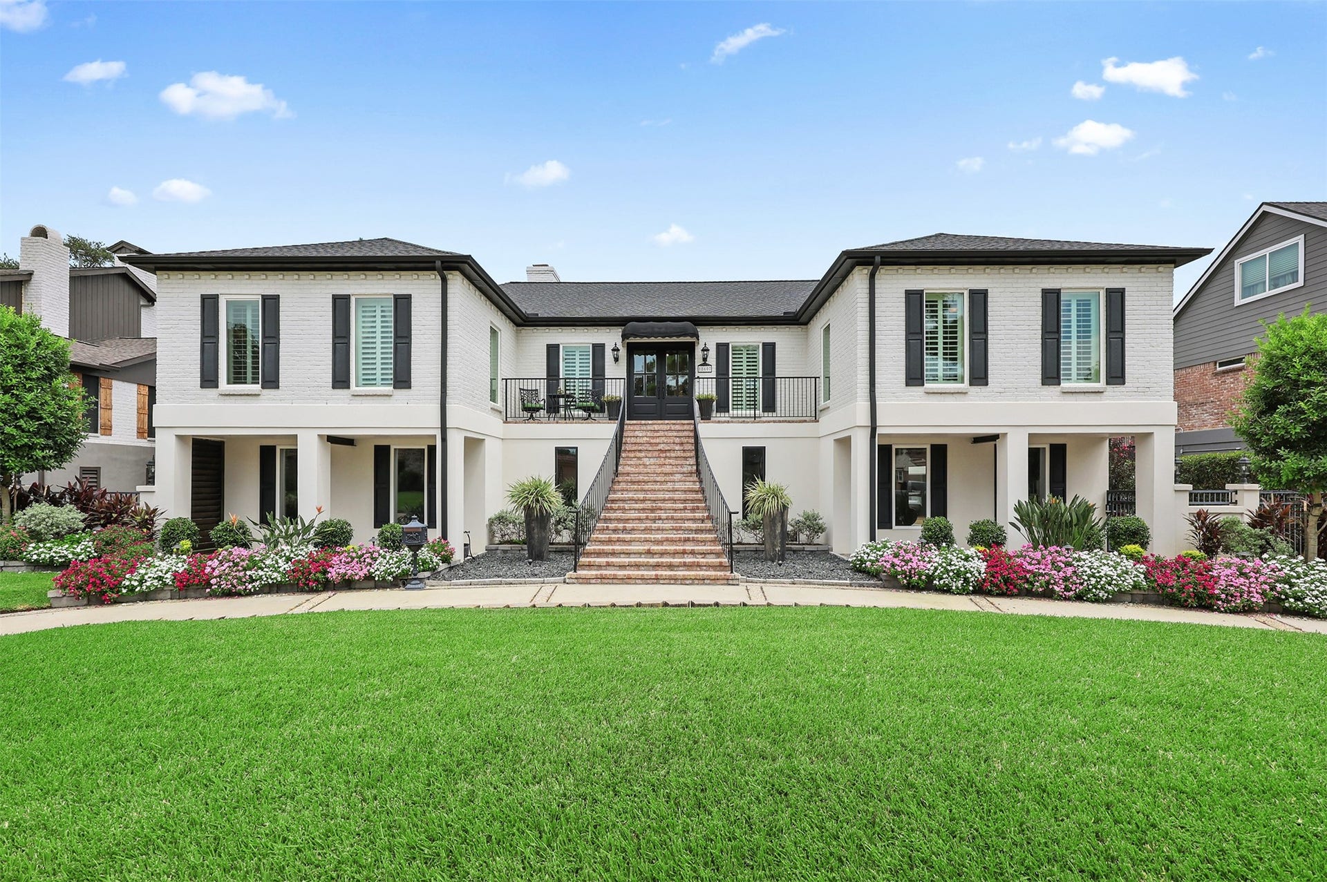 18607 Point Lookout Drive, Nassau Bay, TX 77058 Timeless New Orleans-inspired charm! Beautifully designed with an impressive Old Chicago-style brick staircase, inviting covered porches on either side of the home, and coordinating brick pavers that complement the staircase. Classic black shutters, elegant architectural details, and lush landscaping complete this stunning exterior.