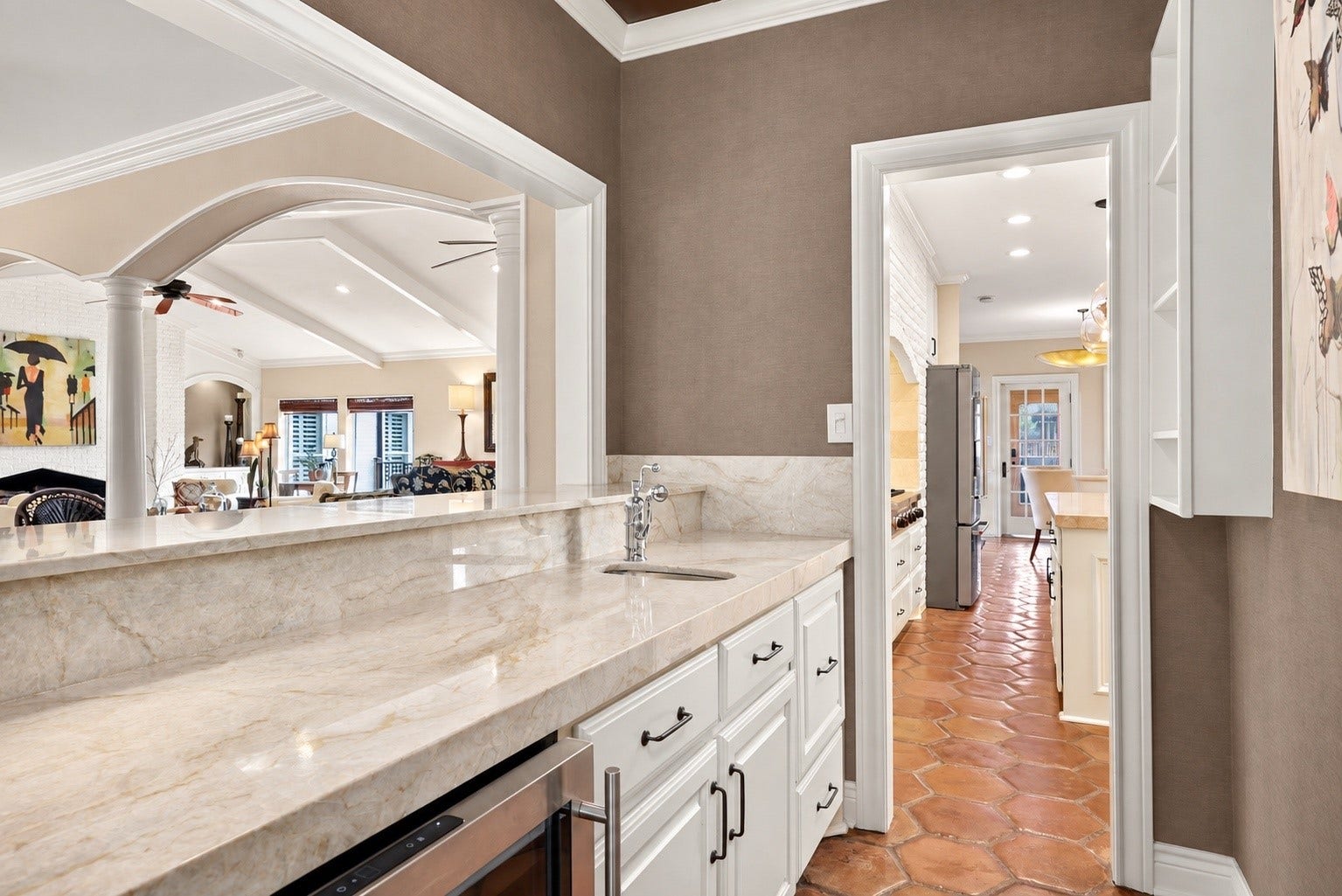 18607 Point Lookout Drive, Nassau Bay, TX 77058 View from the television room looking through the pass-through wet bar toward the kitchen, showcasing the convenient flow between these spaces.