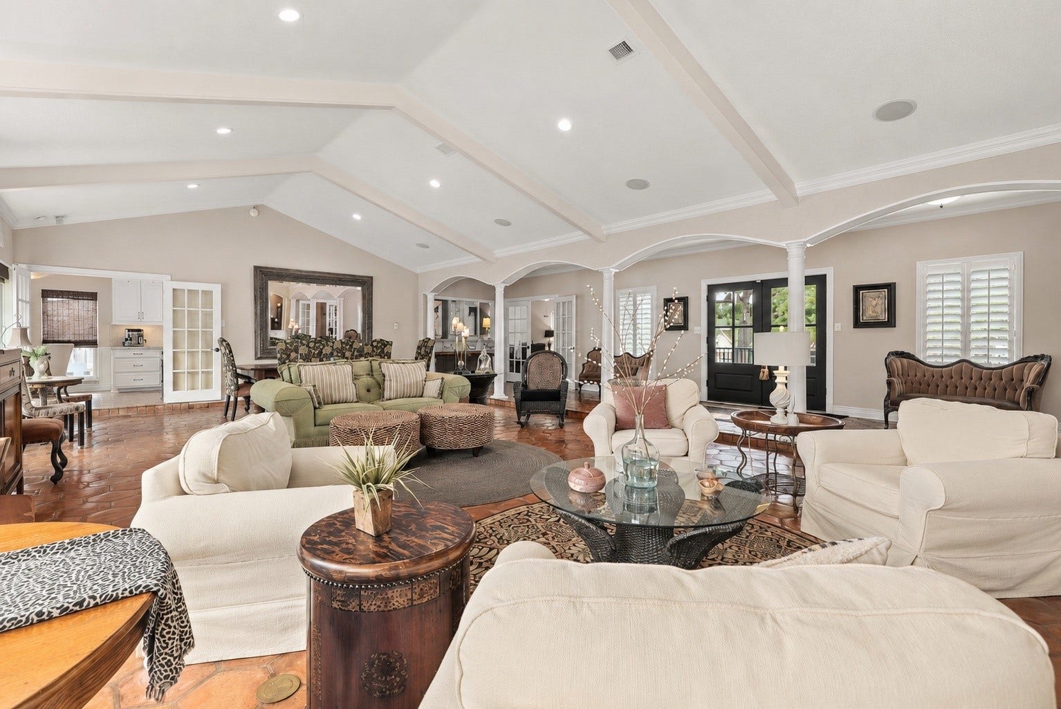 18607 Point Lookout Drive, Nassau Bay, TX 77058 An entertainer's dream! This expansive, open-concept living area offers three distinct seating areas, beautiful architectural arches, soaring beamed ceilings, and authentic octagonal Saltillo tile flooring. Enjoy an easy flow to the kitchen through French doors, with a convenient wet bar and separate television room nearby. Updated front entry doors complete with warm and inviting space, perfect for gatherings large or small.