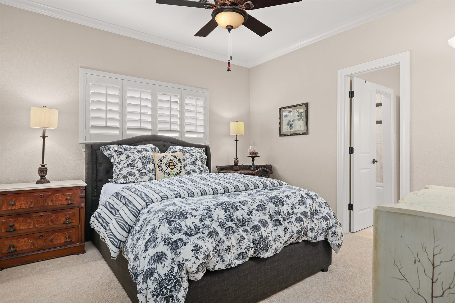 18607 Point Lookout Drive, Nassau Bay, TX 77058 Spacious bedroom #2 features beautiful plantation shutters and access to a generously sized bathroom with 36-inch high cabinetry, abundant built-in storage, and ample counter space for guests to comfortably spread out and feel at home. The bathroom also connects to bedroom #3, currently used as a home office, offering a convenient and versatile shared-bath arrangement.