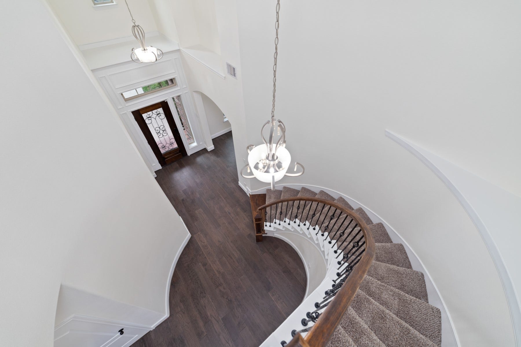 11103 Dowbeck Avenue, Richmond, TX 77407 This home features a stunning curved staircase that adds elegance and creates a striking architectural focal point.