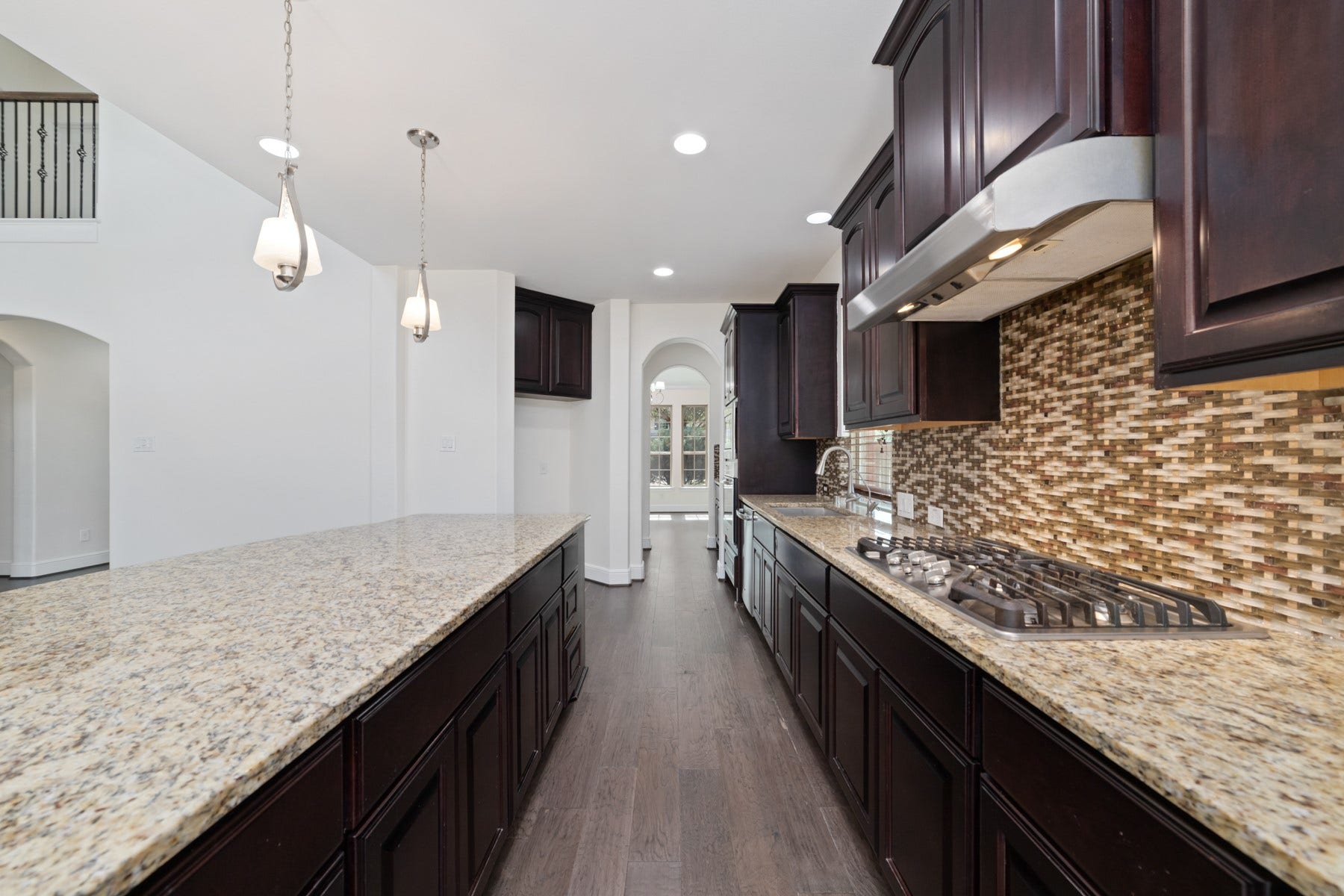 11103 Dowbeck Avenue, Richmond, TX 77407 This modern kitchen boasts a spacious granite island, ideal for entertaining and creating memorable culinary experiences.