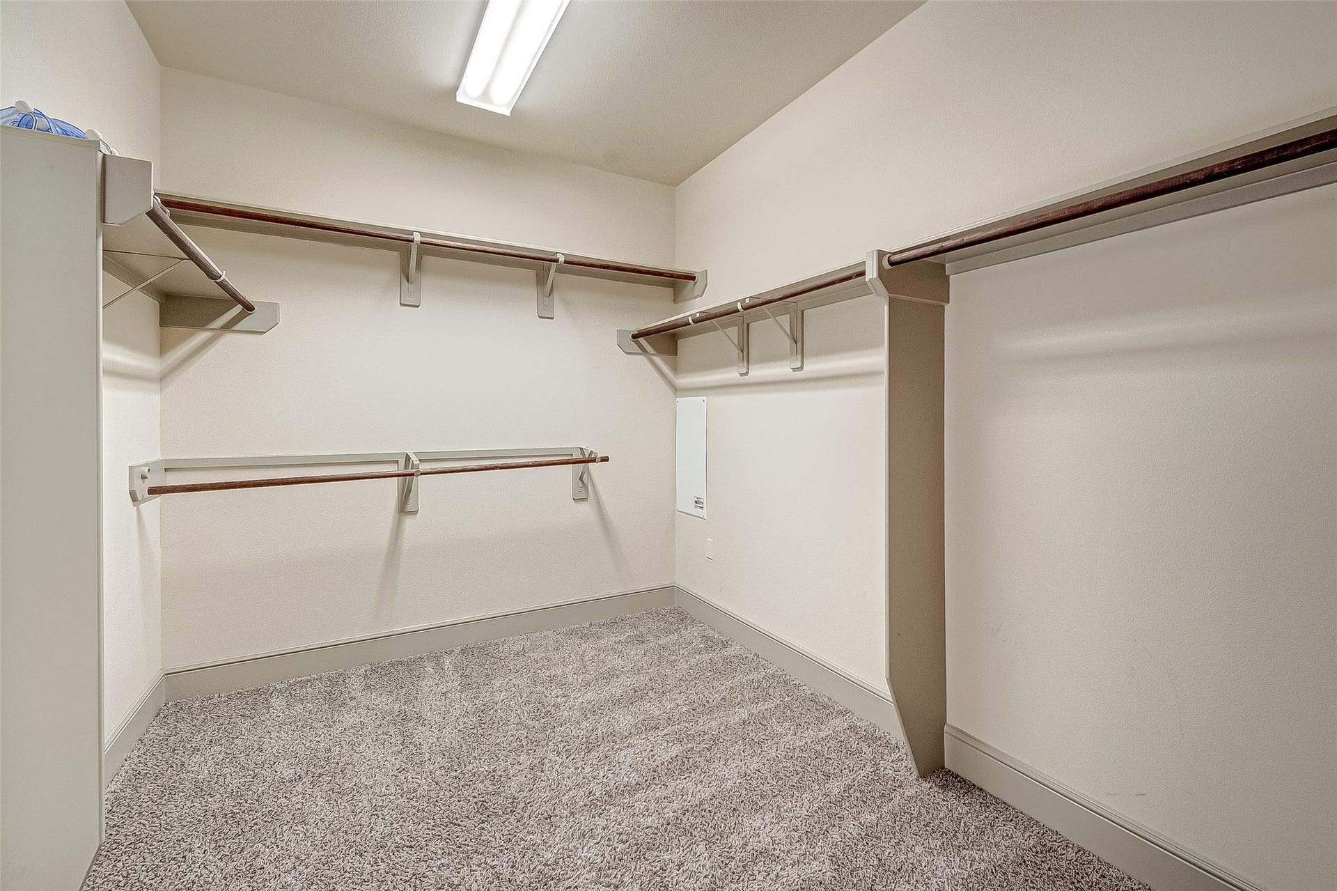 11103 Dowbeck Avenue, Richmond, TX 77407 Spacious walk-in closet featuring ample shelving and hanging rods, with soft carpeted flooring and bright overhead lighting.