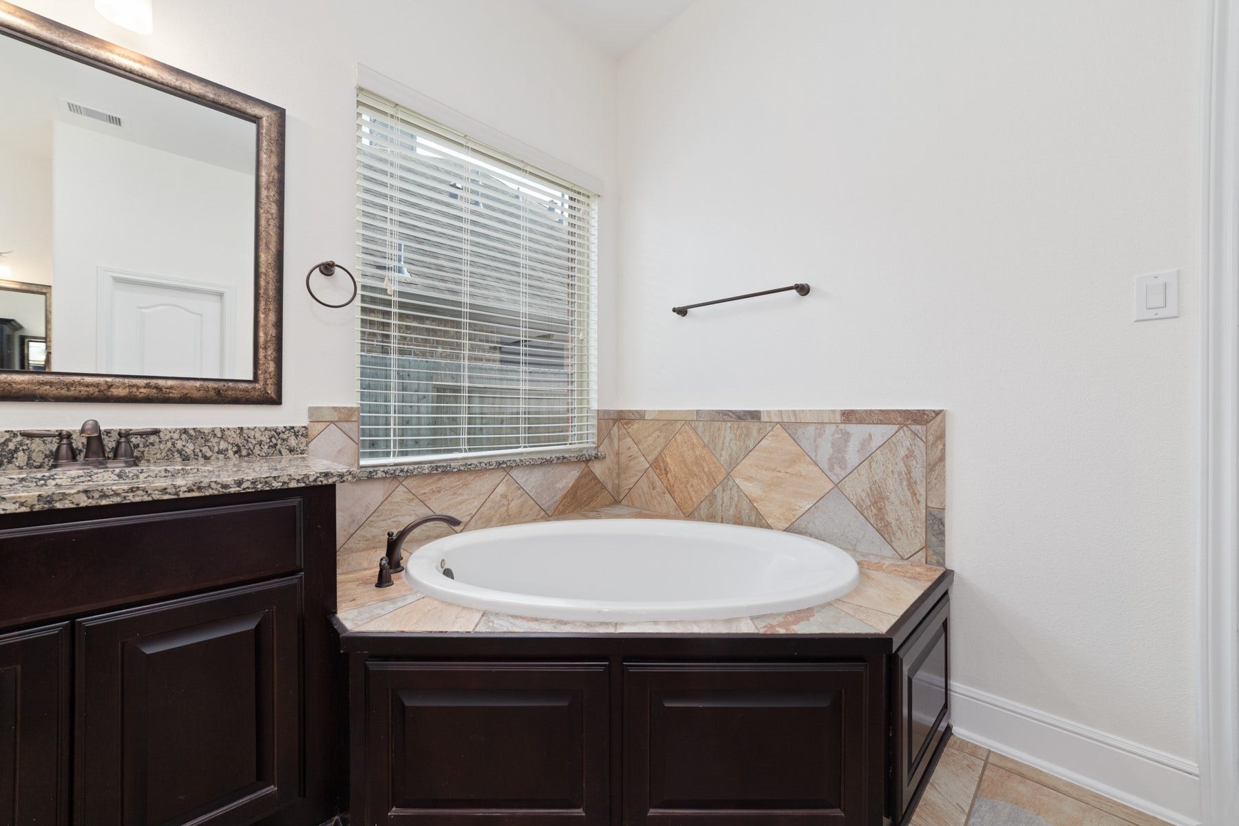 11103 Dowbeck Avenue, Richmond, TX 77407 The primary bathroom features a garden tub, perfect for relaxing after a long day.