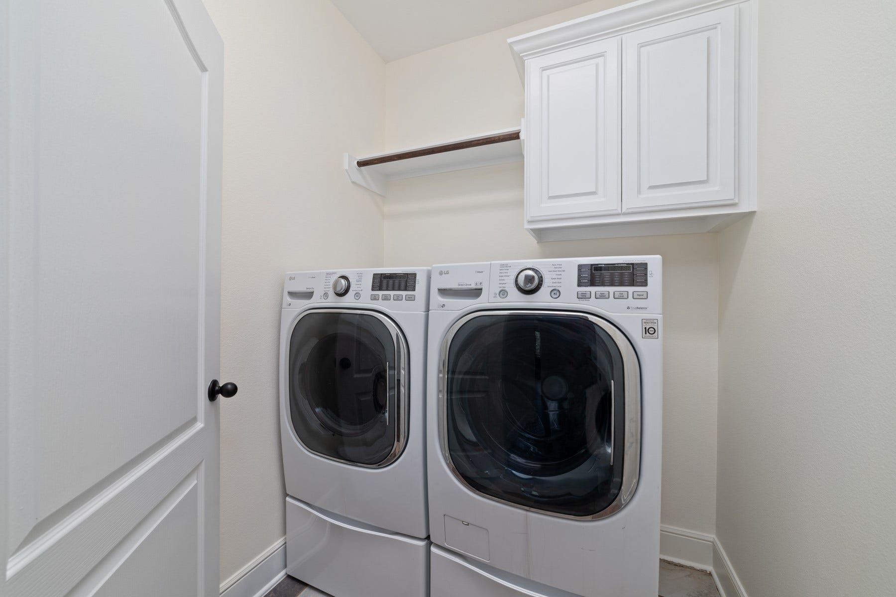 11103 Dowbeck Avenue, Richmond, TX 77407 This laundry room with a shelf above for storage and a cabinet for additional storage space. Washer and dryer included