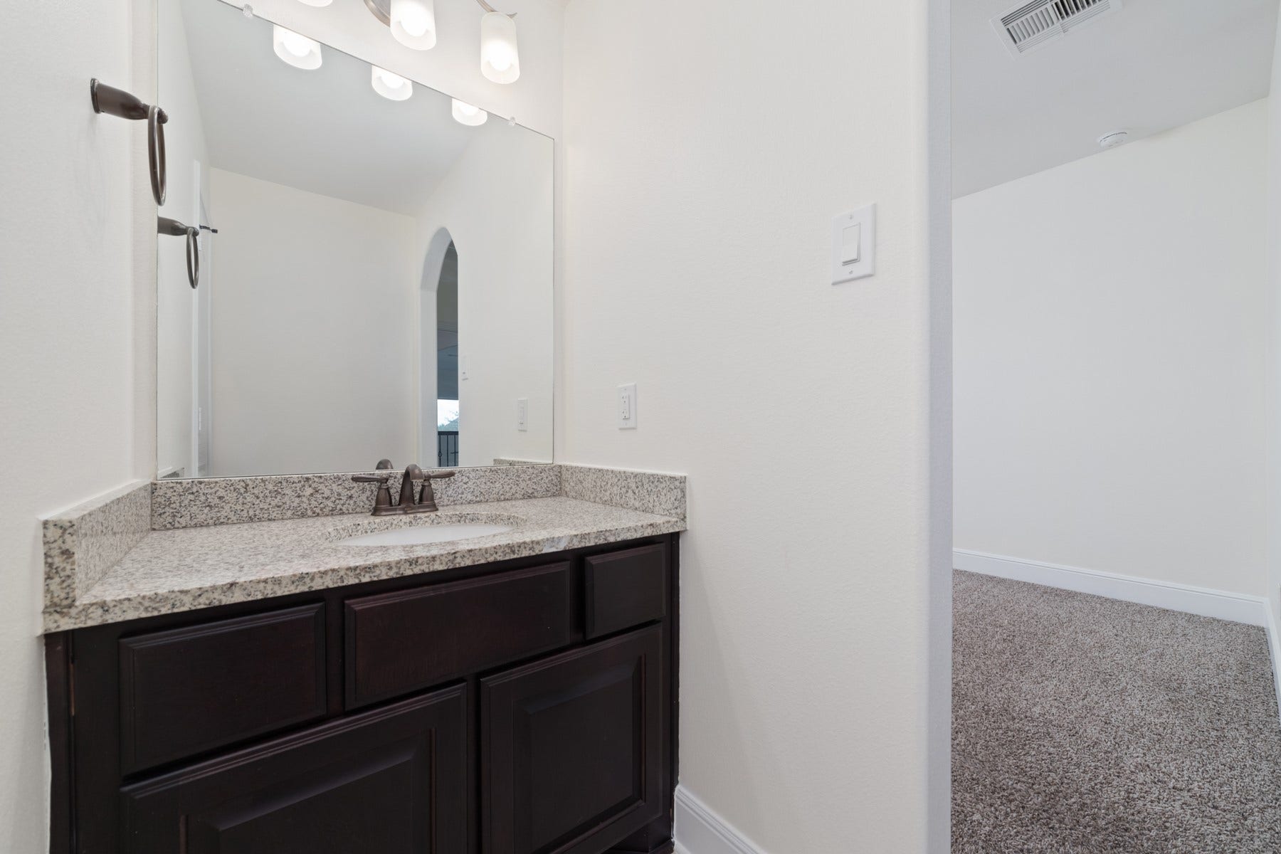 11103 Dowbeck Avenue, Richmond, TX 77407 This modern bathroom features bronze fixtures, and overhead lighting.