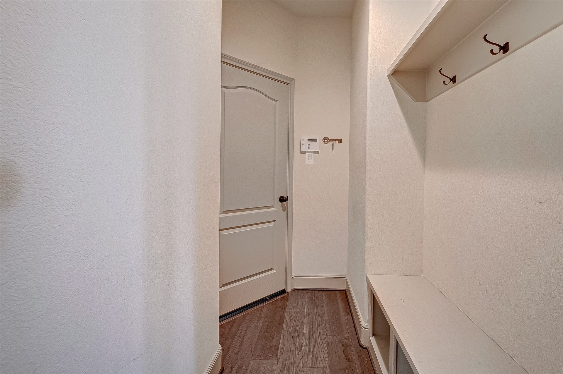 11103 Dowbeck Avenue, Richmond, TX 77407 The neutral color palette enhances the mud room's welcoming and functional ambiance.